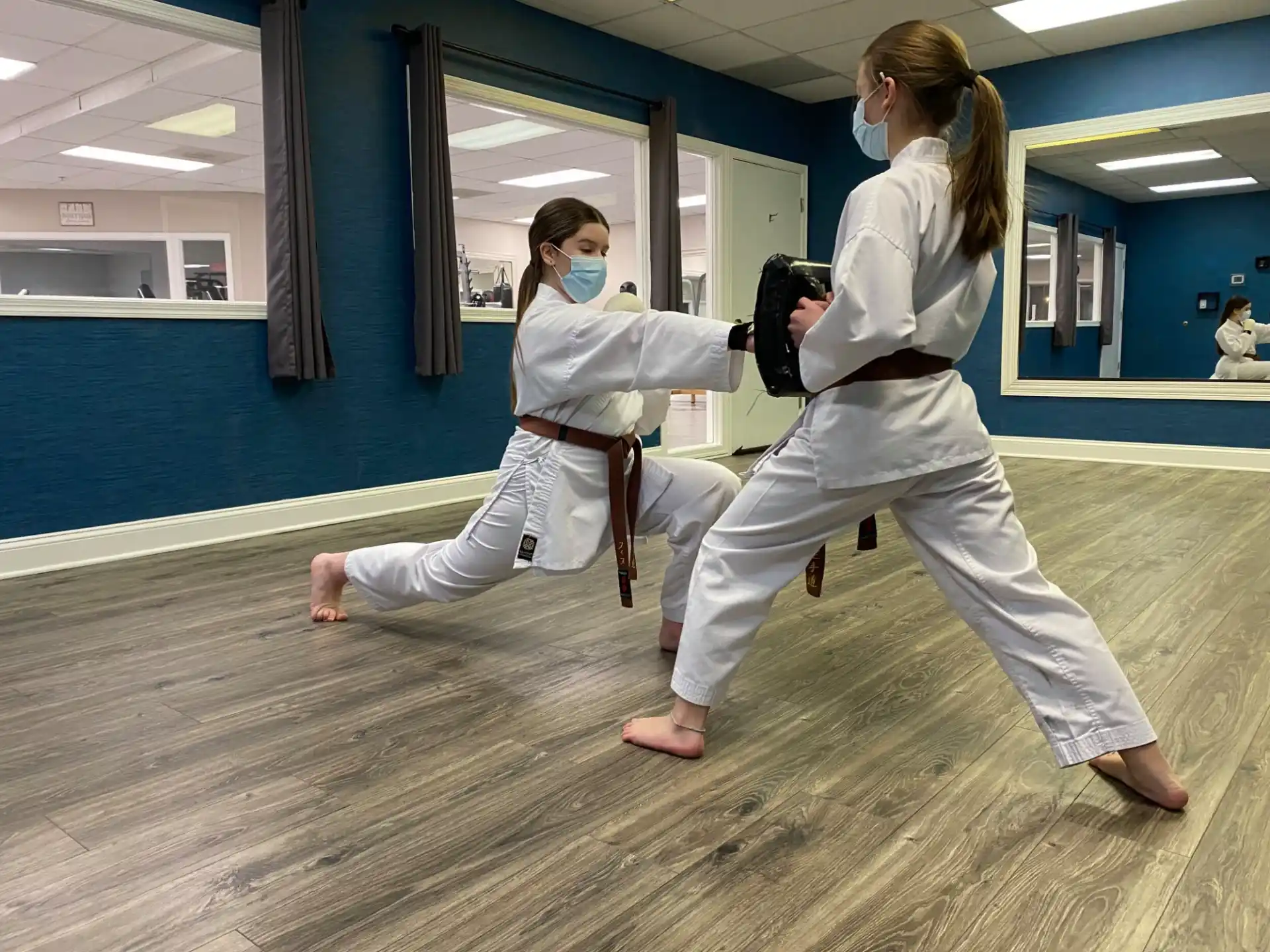 a couple of women in karate uniforms