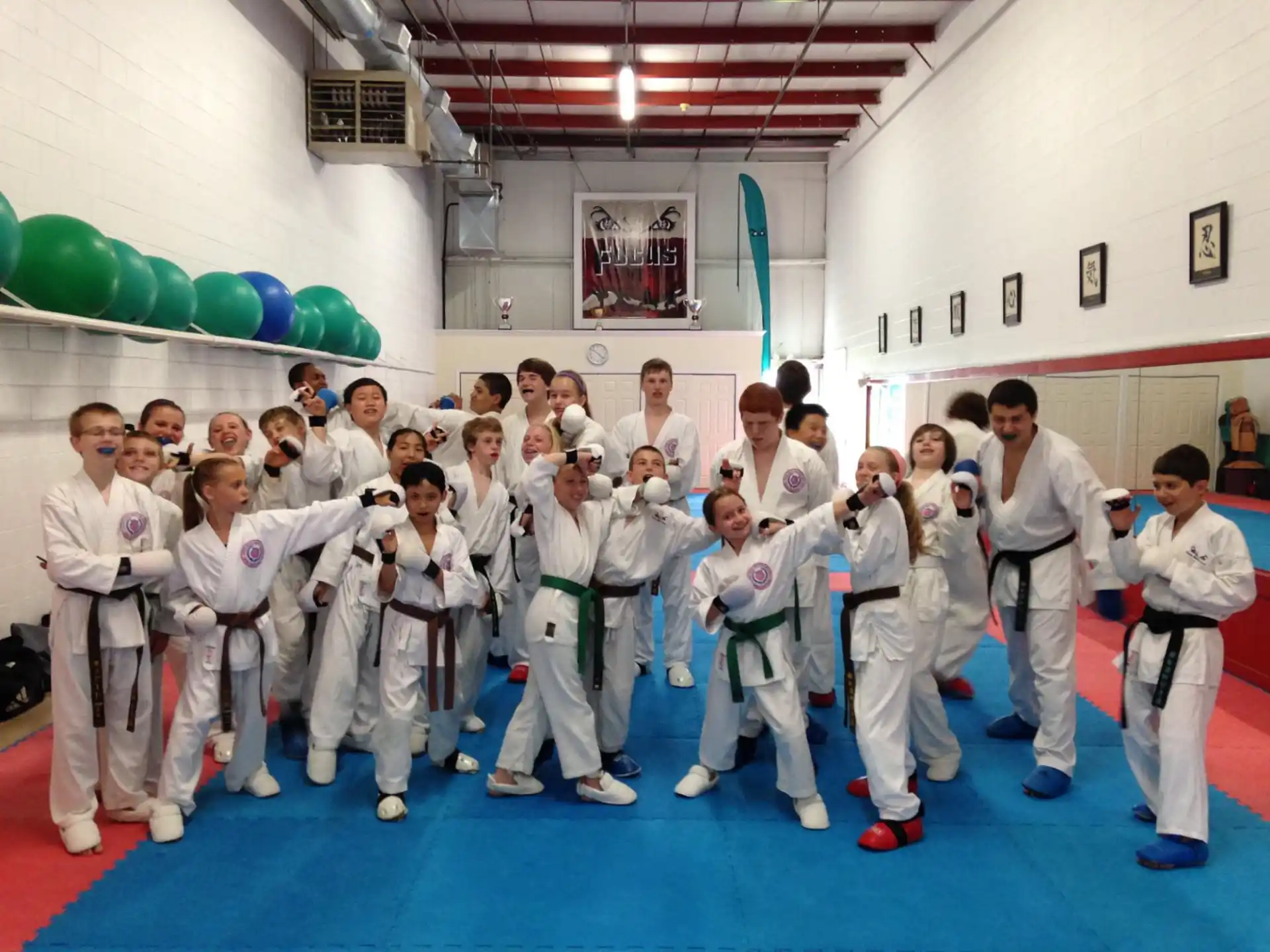 a group of people in white karate uniforms