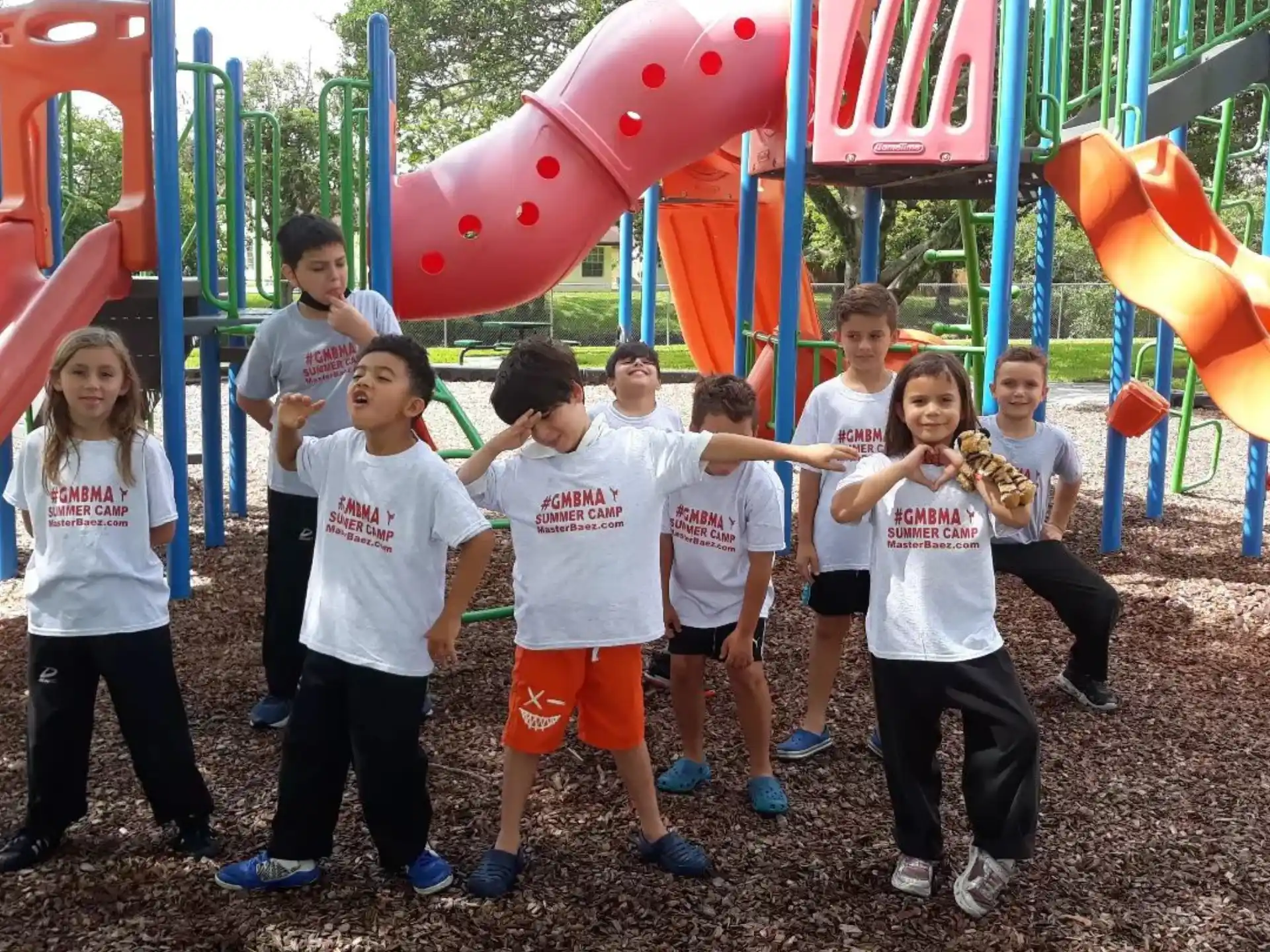 a group of children posing for a photo in front of a large balloon