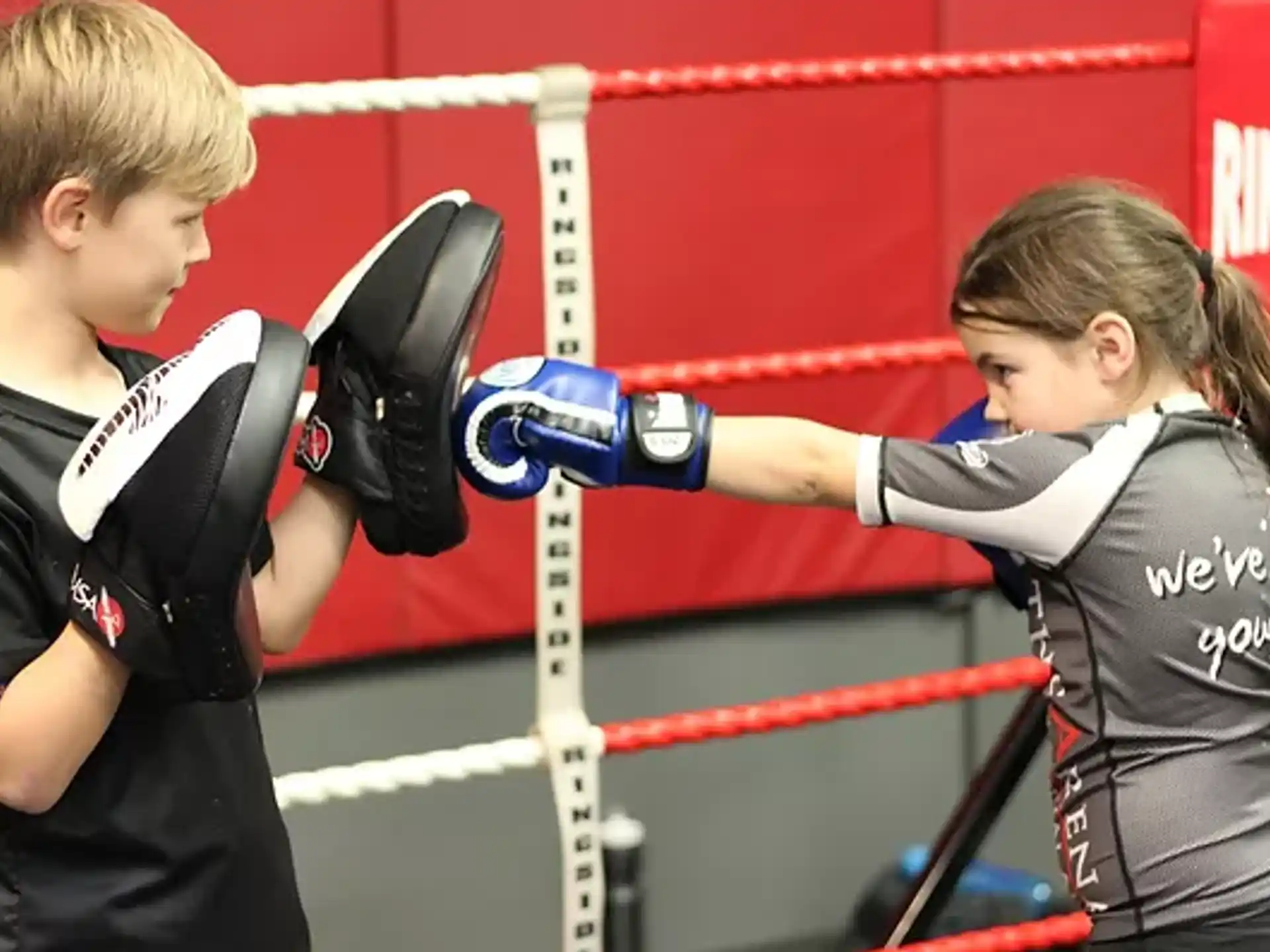a couple of women wearing boxing gloves