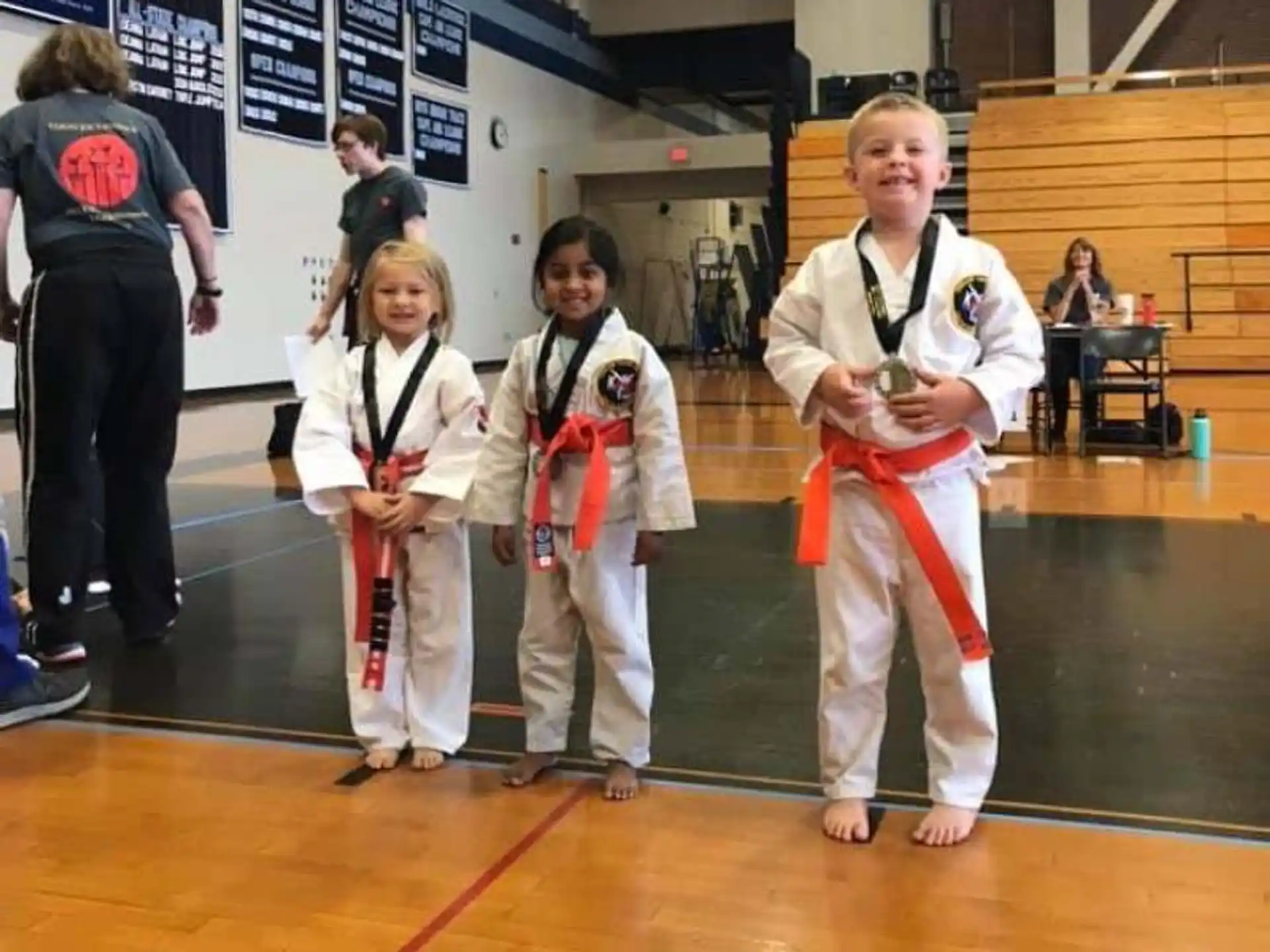 a group of girls in karate uniforms