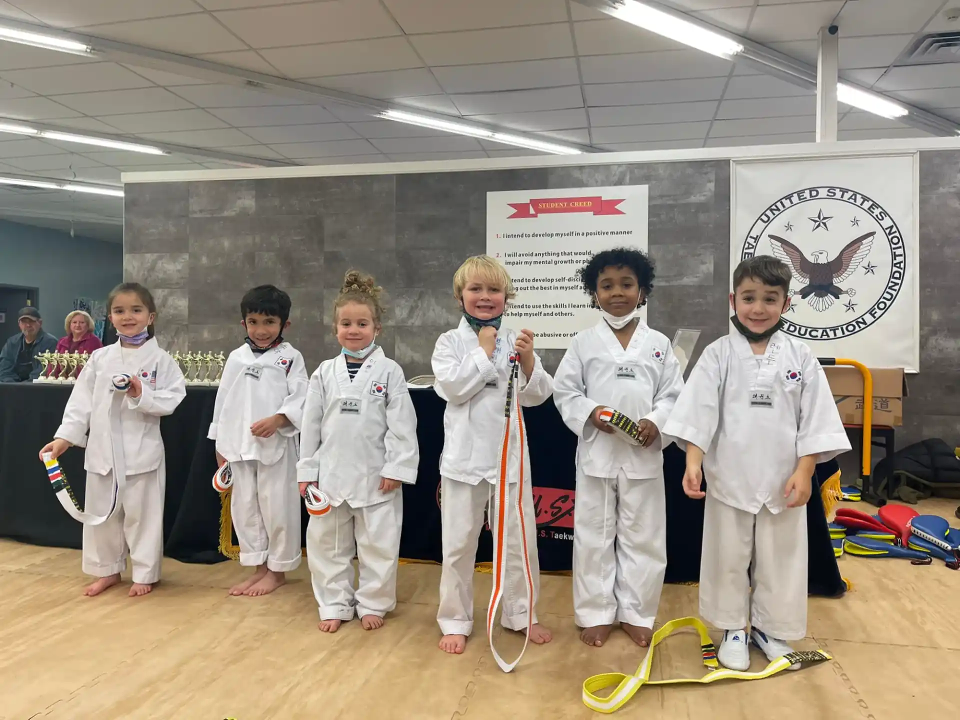 a group of kids in karate uniforms