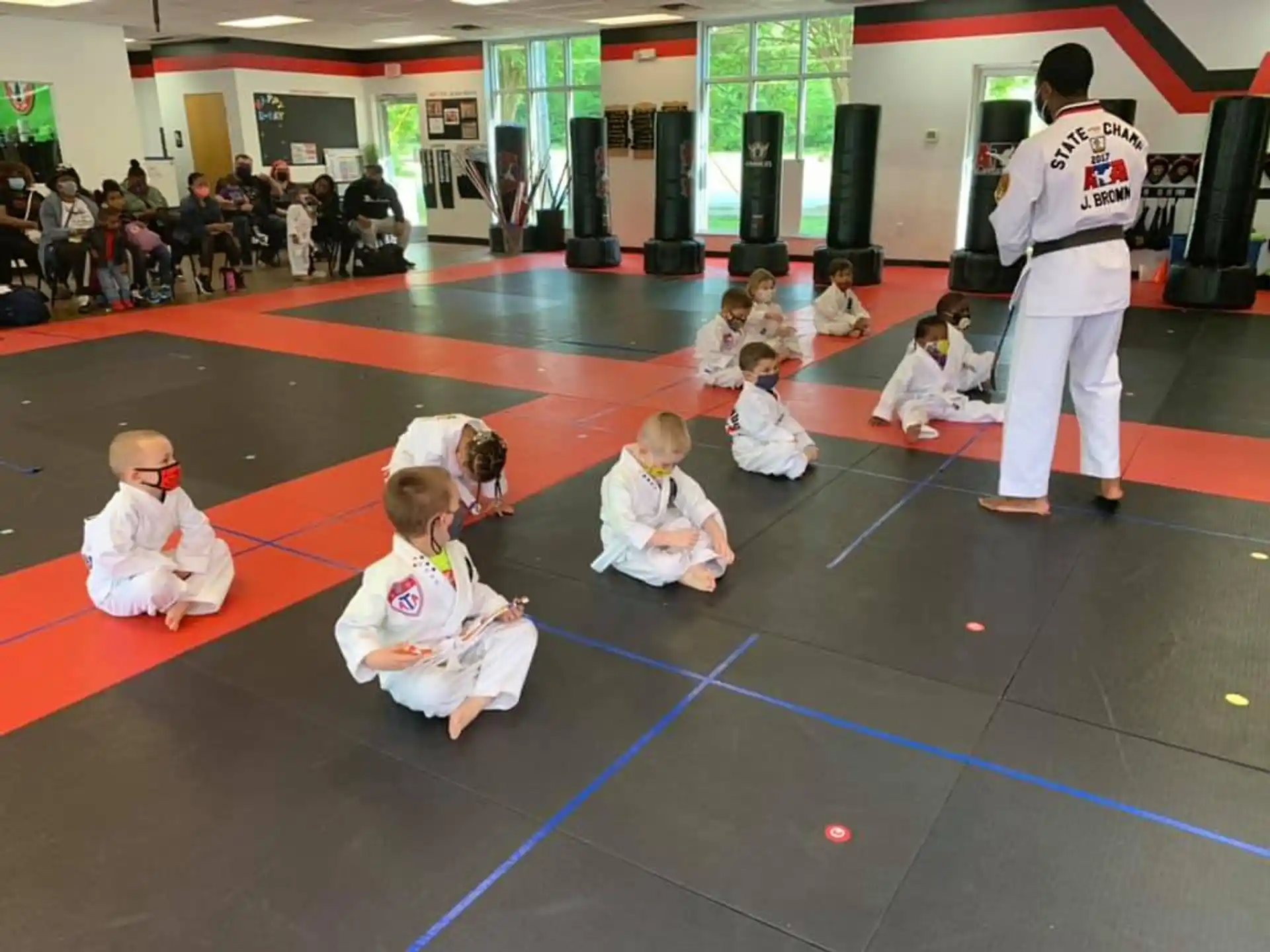 a group of children in karate uniforms