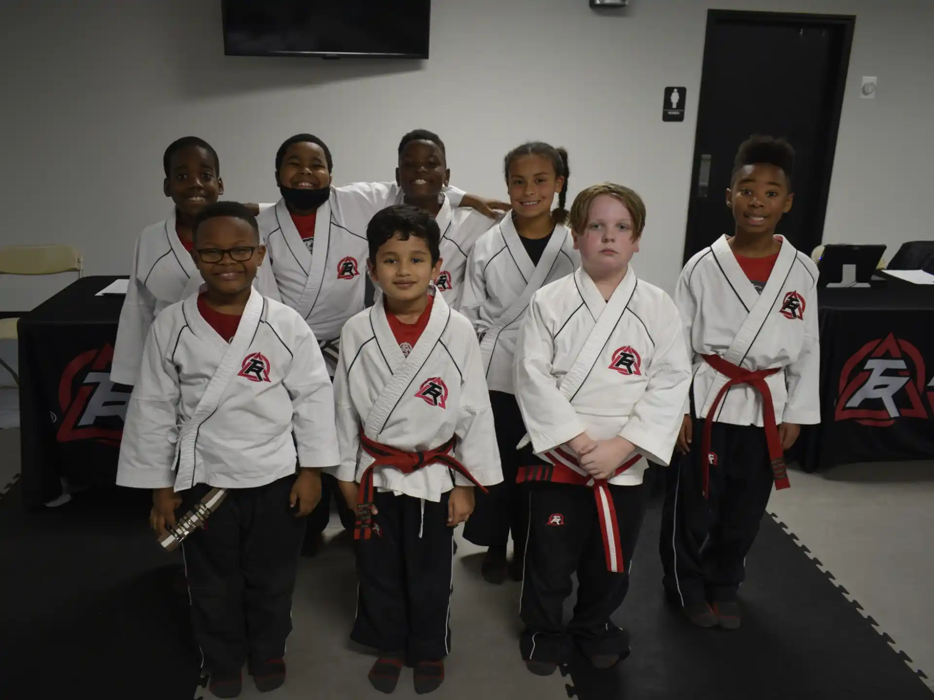 a group of people wearing white and red uniforms