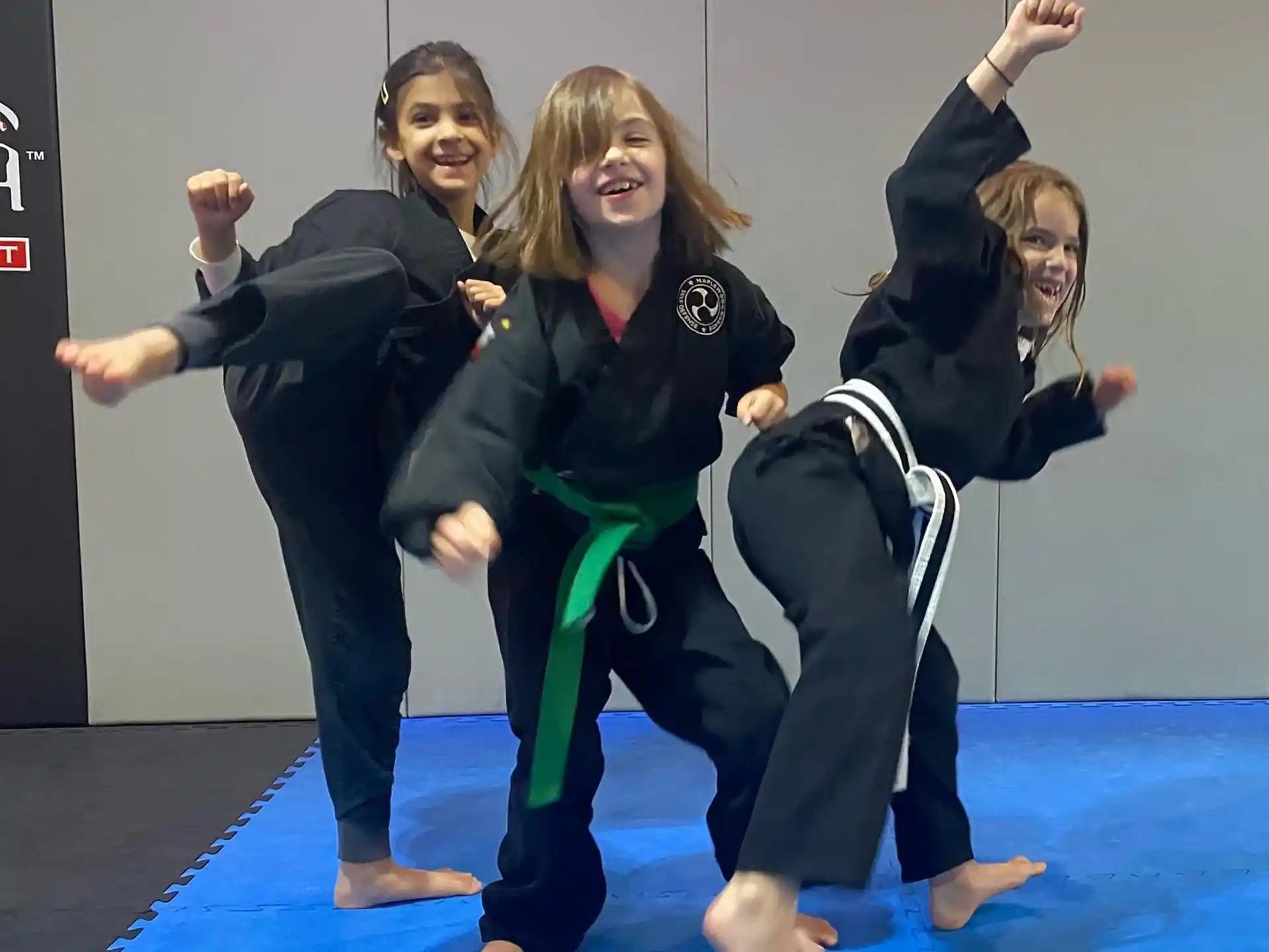 a group of women in black pants and green pants posing for a photo