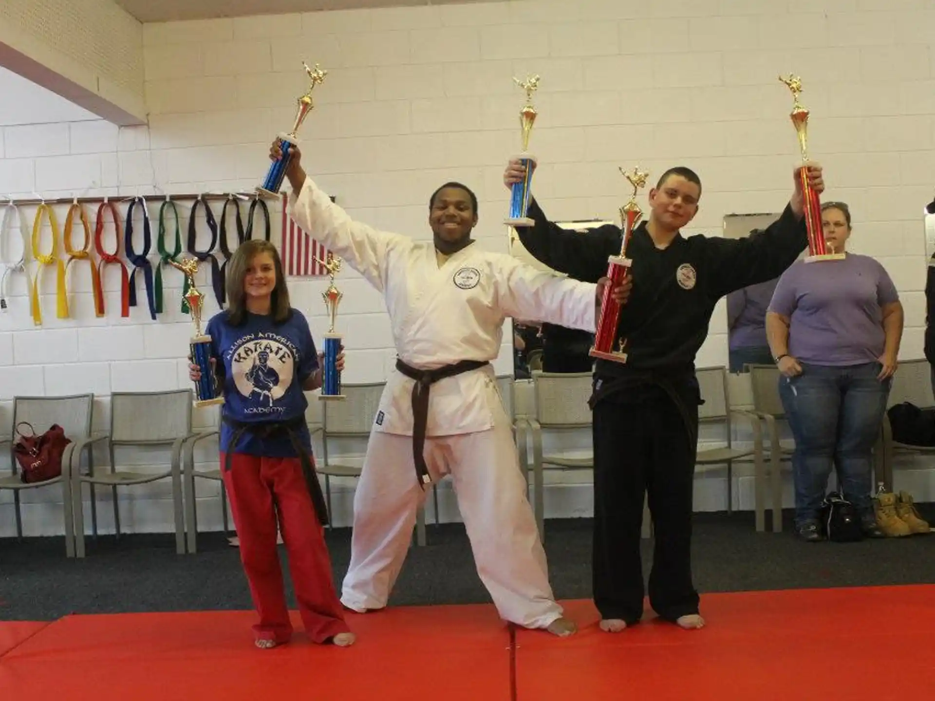 a group of people in martial arts uniforms posing for a photo