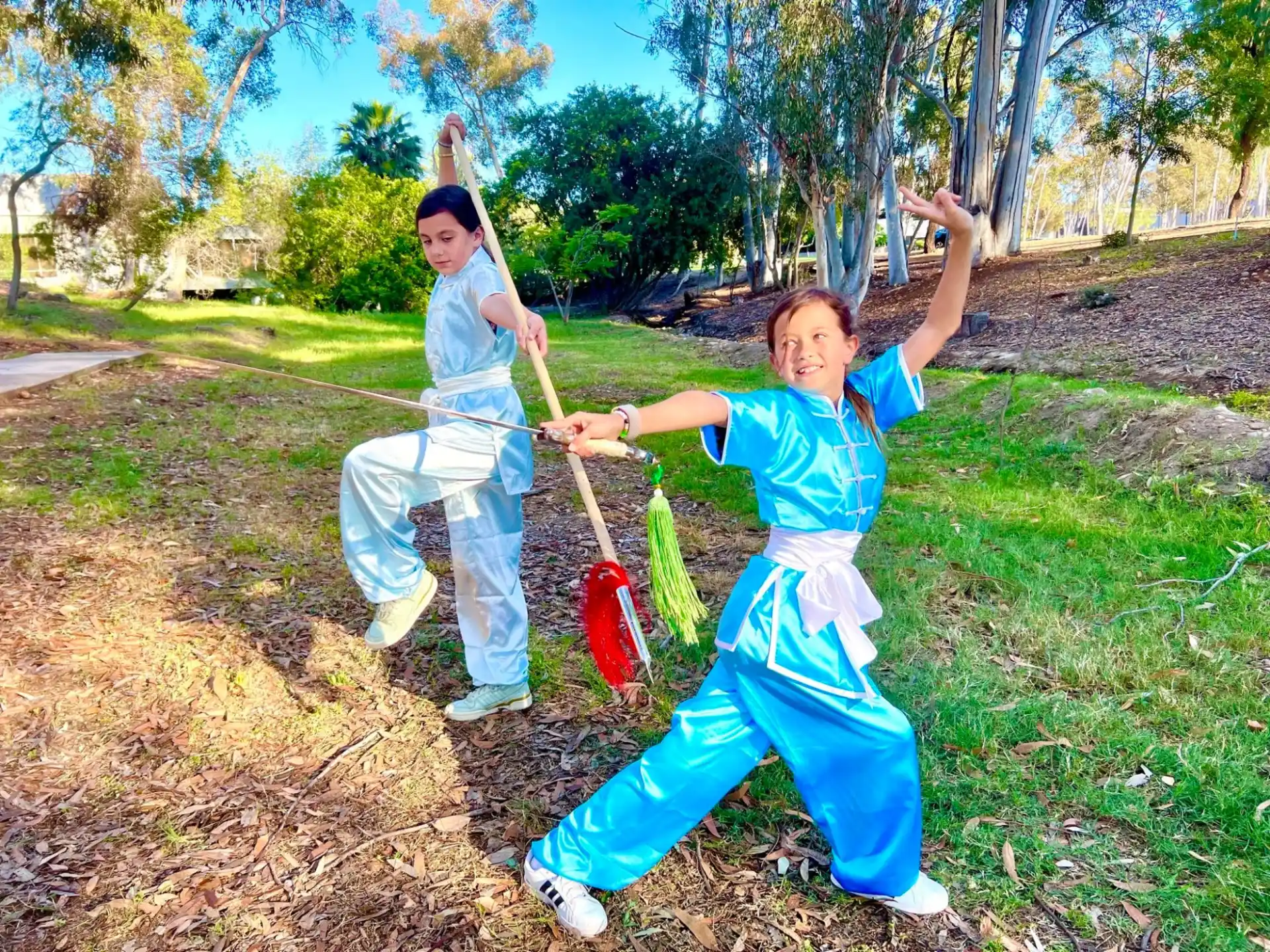 a couple of people holding objects posing for the camera