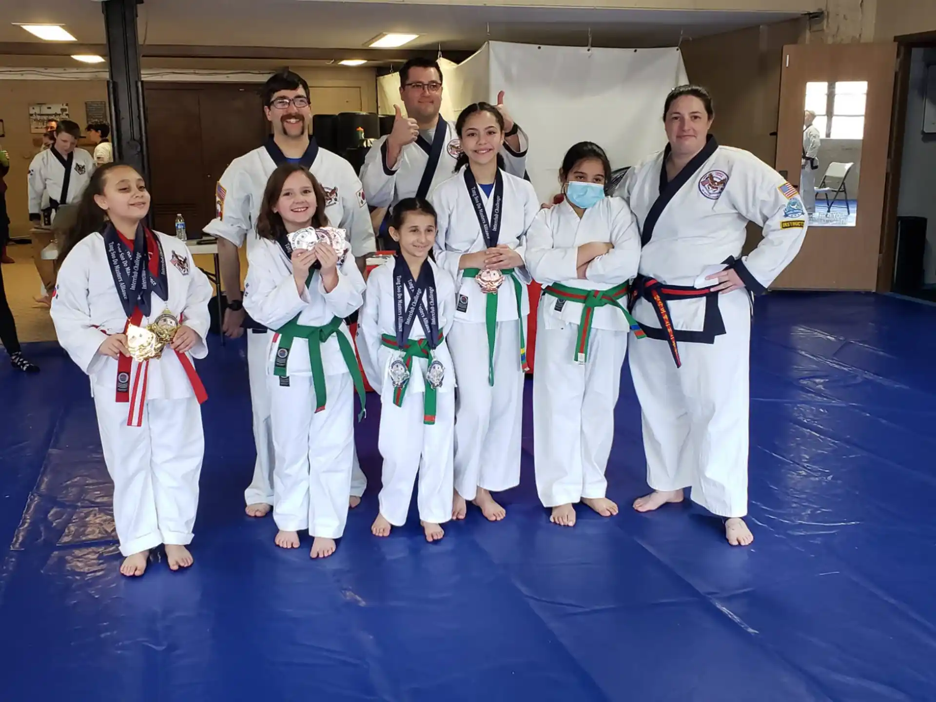 a group of people in karate uniforms