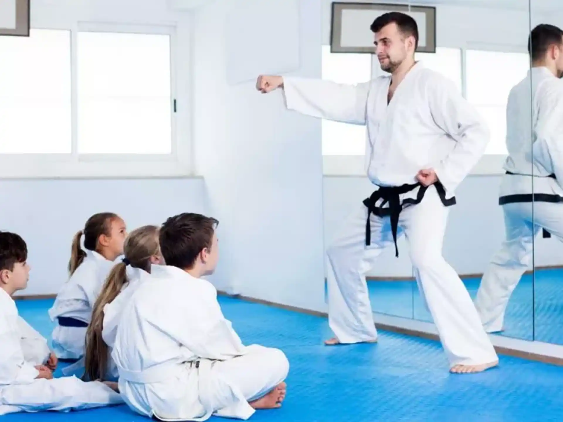 a group of people in karate uniforms