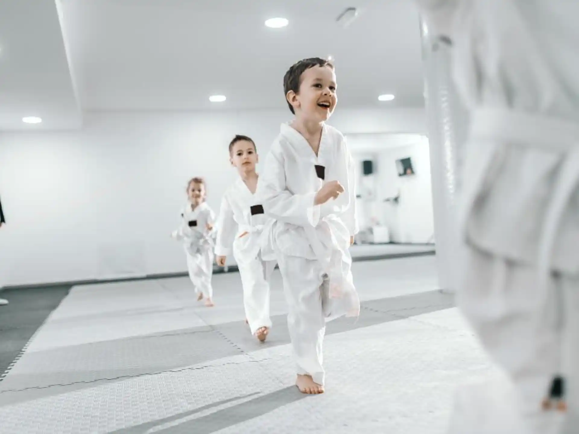 a group of people in white karate uniforms