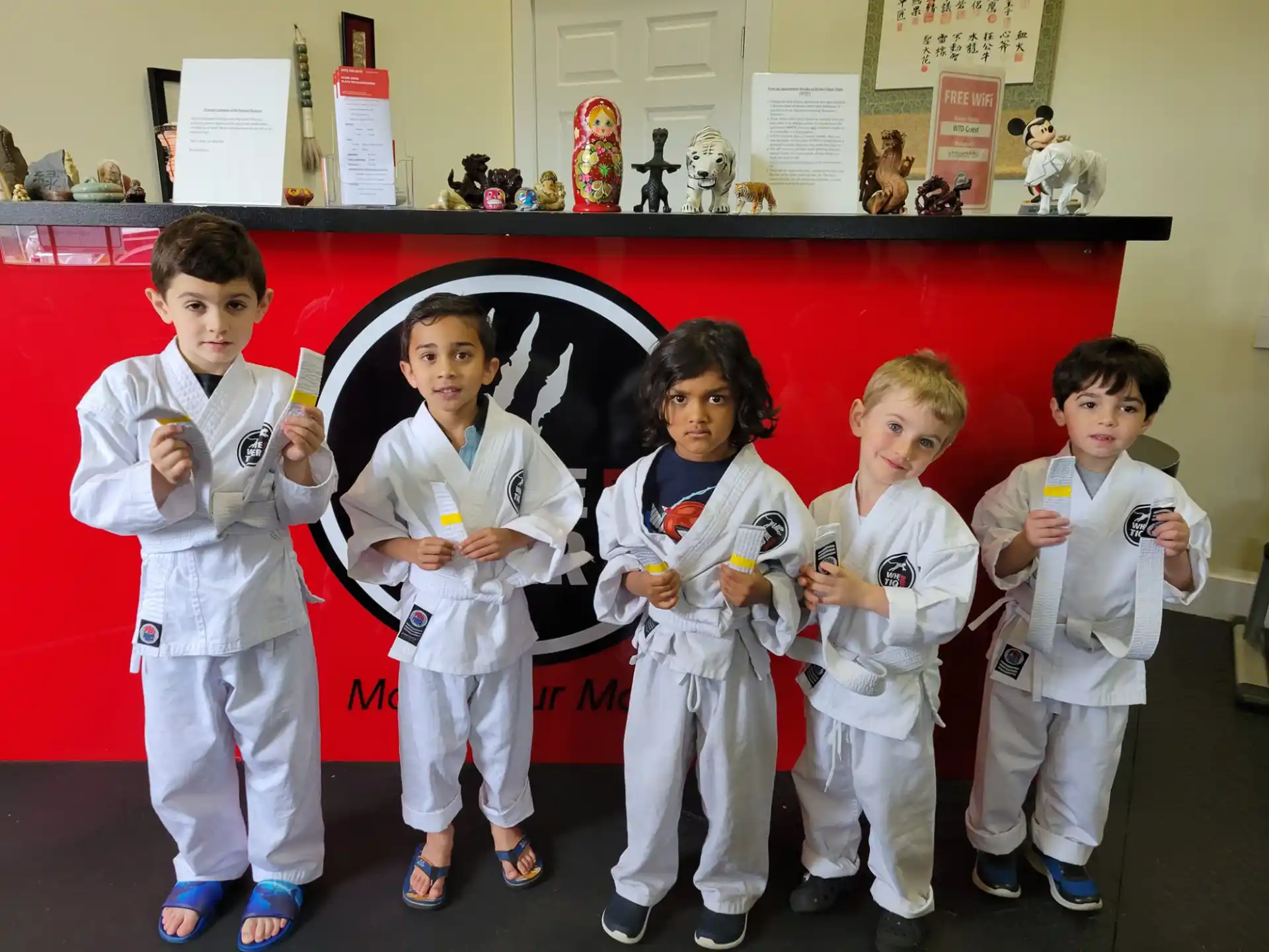 a group of kids in karate uniforms