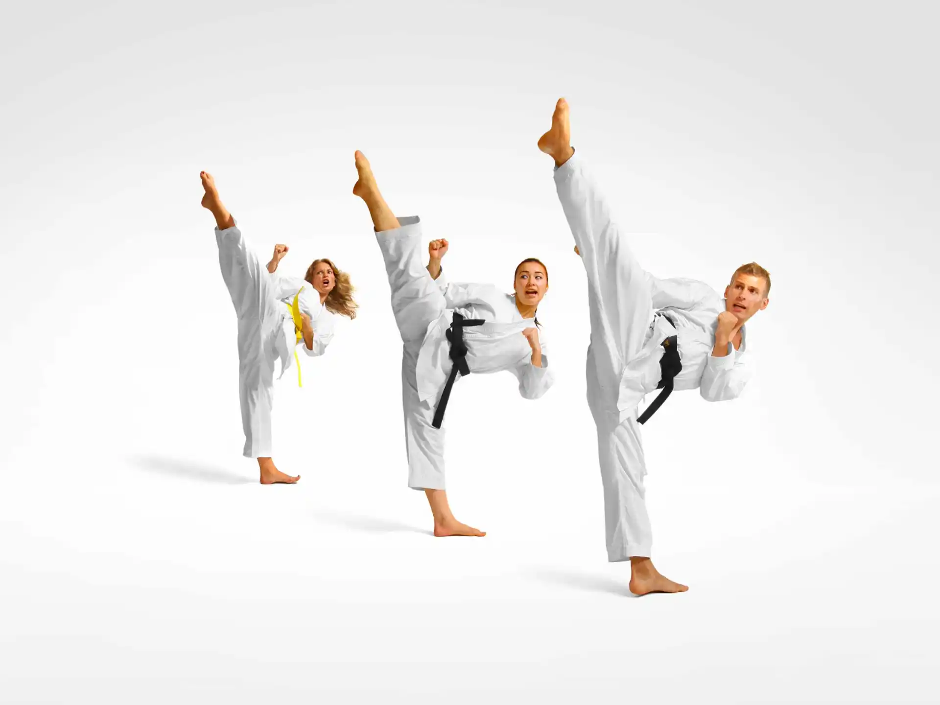 a group of people in white karate uniforms