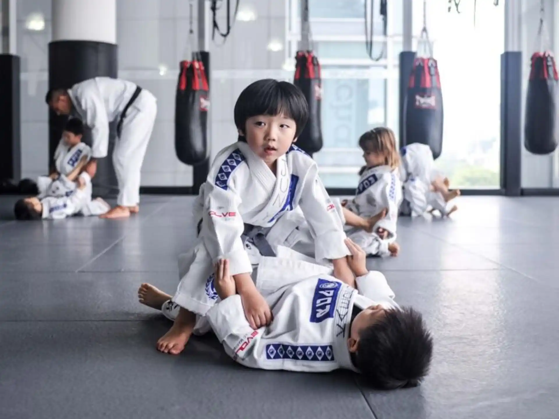 a group of children in karate uniforms