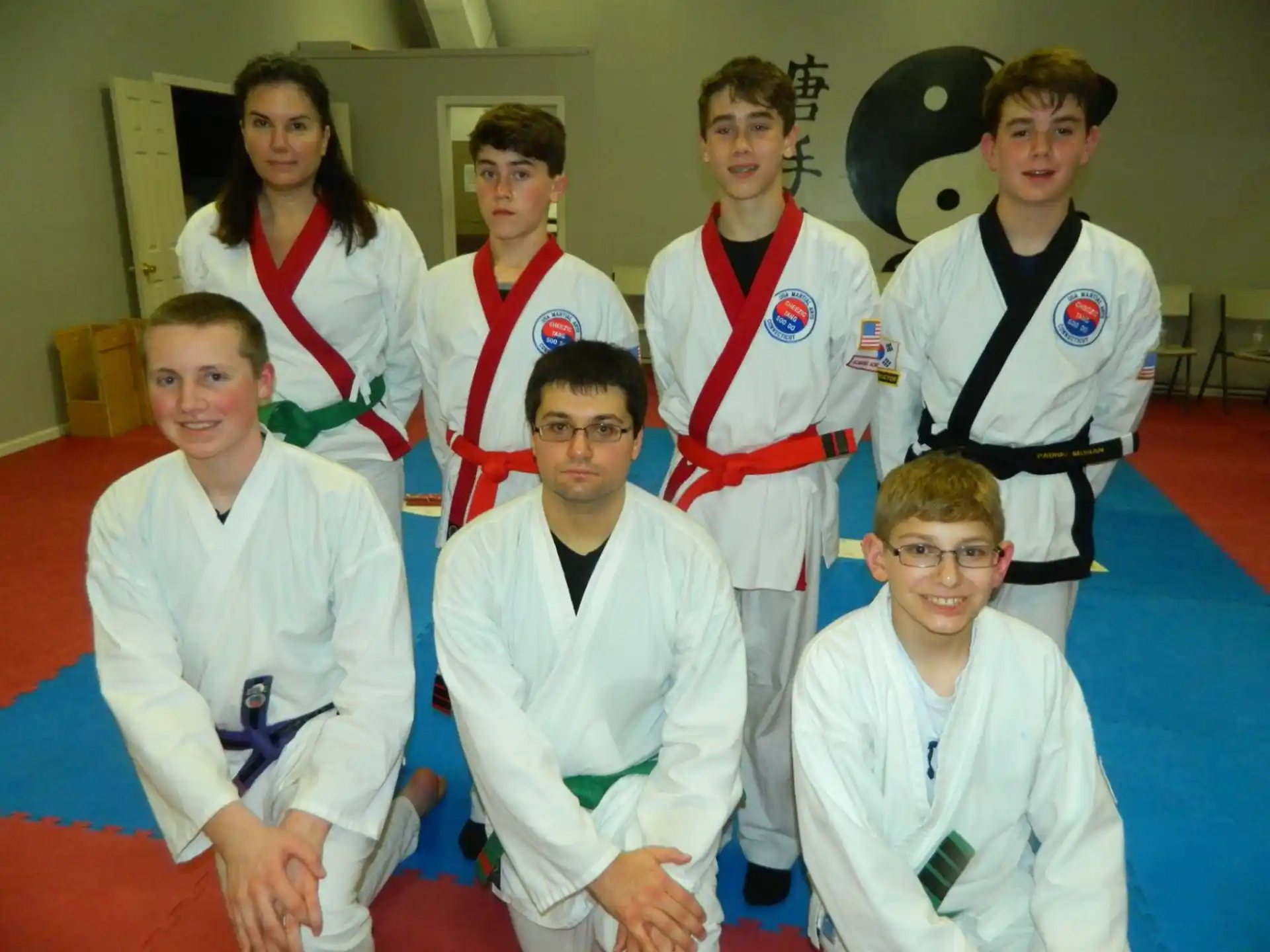 a group of people in karate uniforms