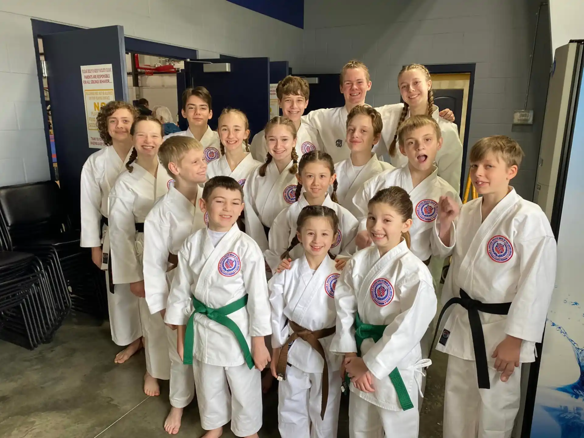 a group of children in white karate uniforms