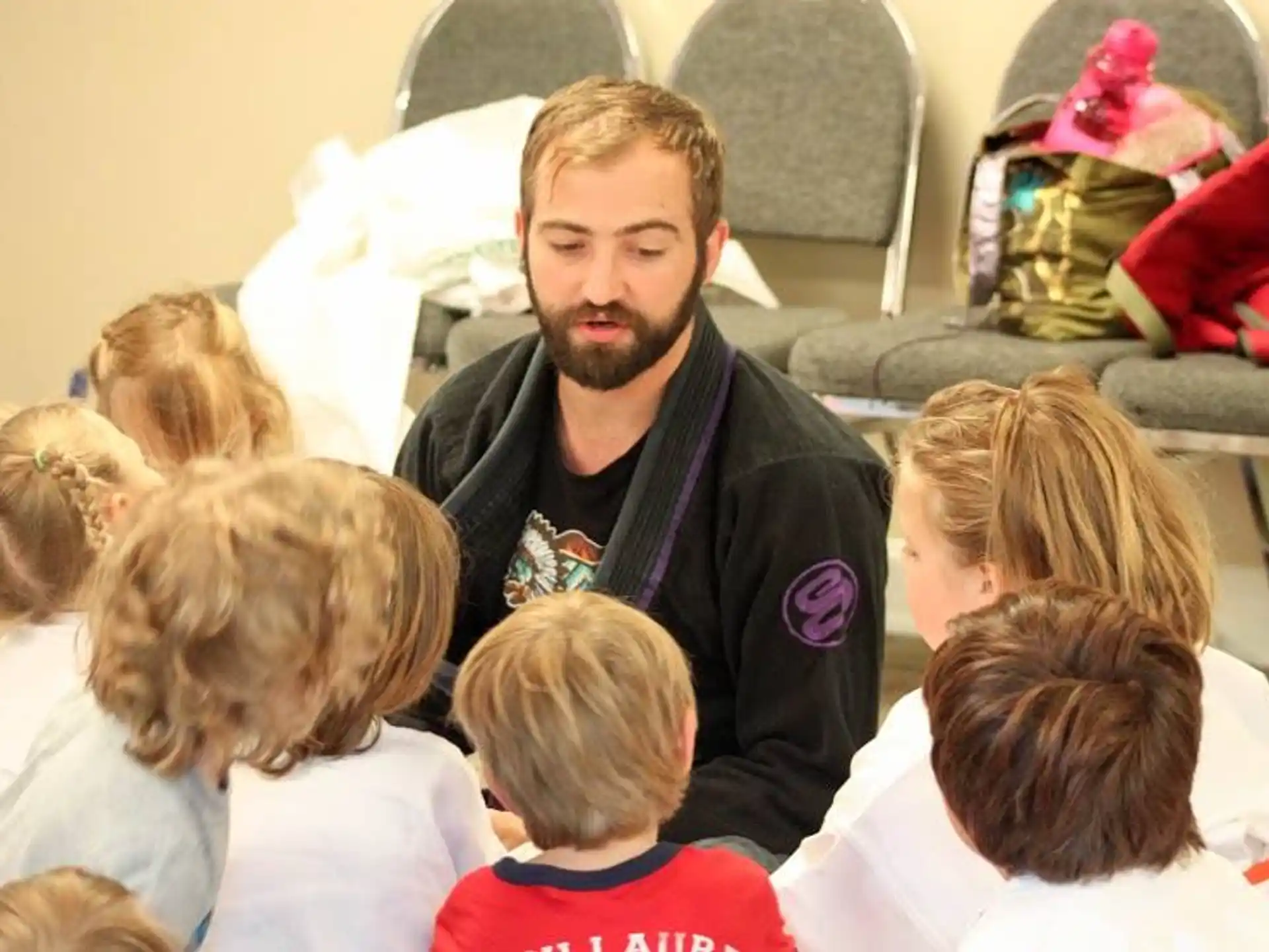 a person standing in front of a group of children