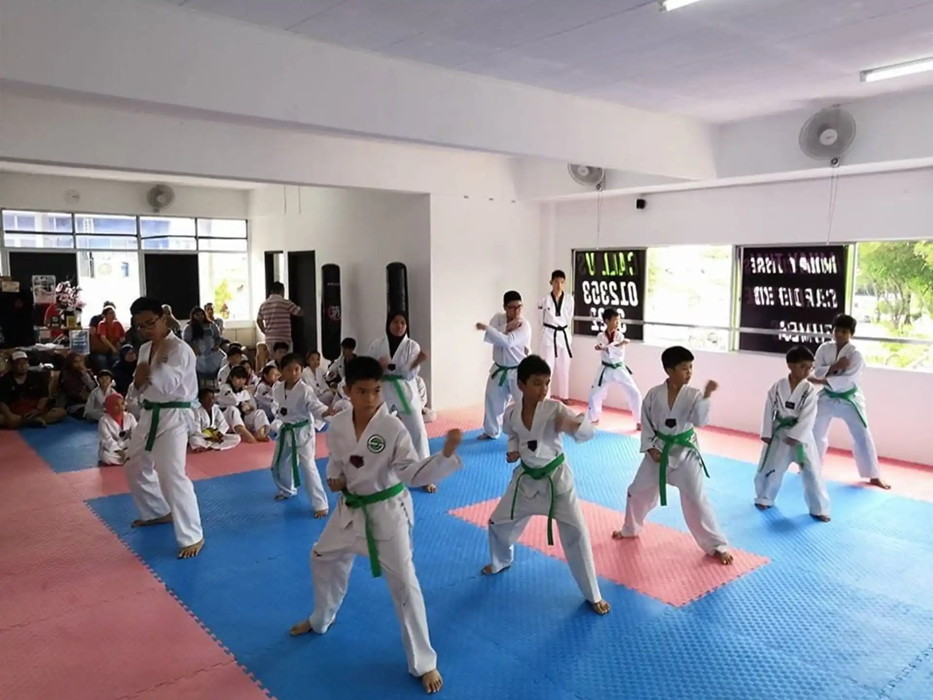 a group of people in karate uniforms