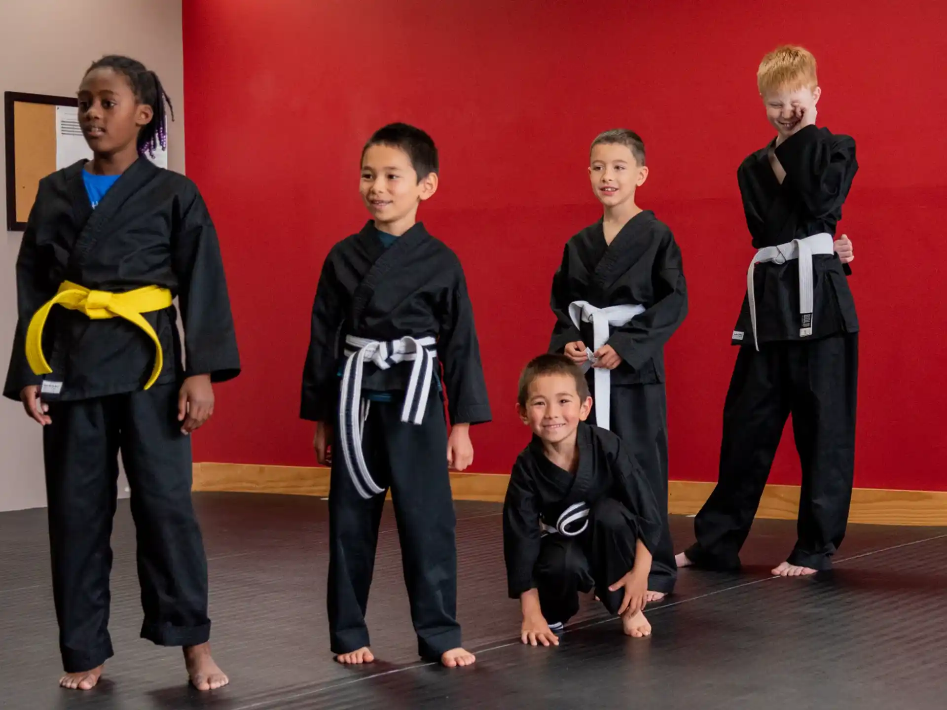 a group of children in black karate uniforms