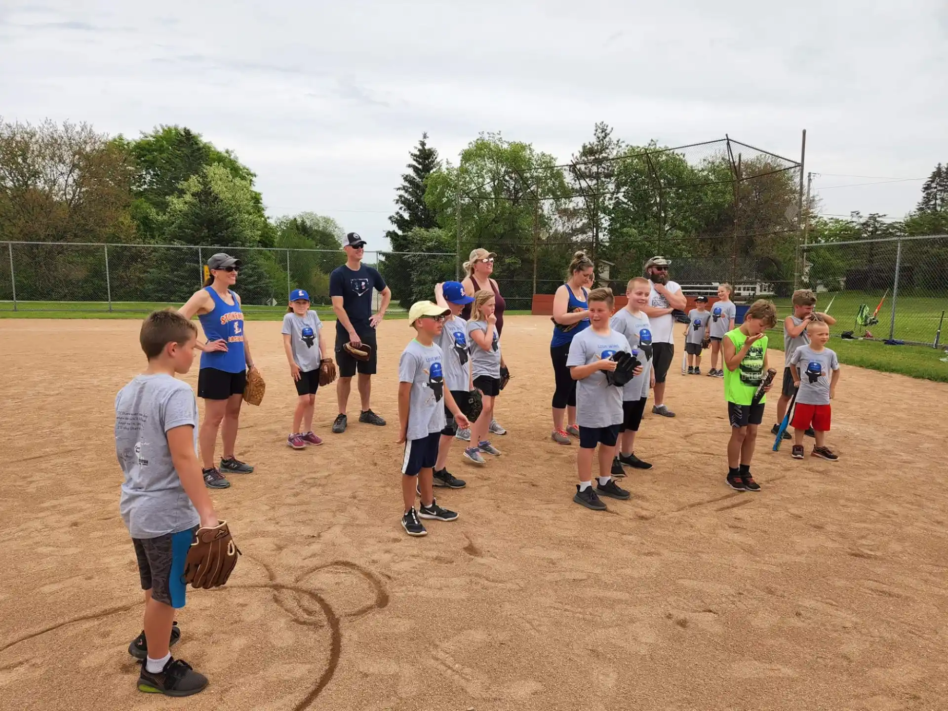 a group of kids playing baseball
