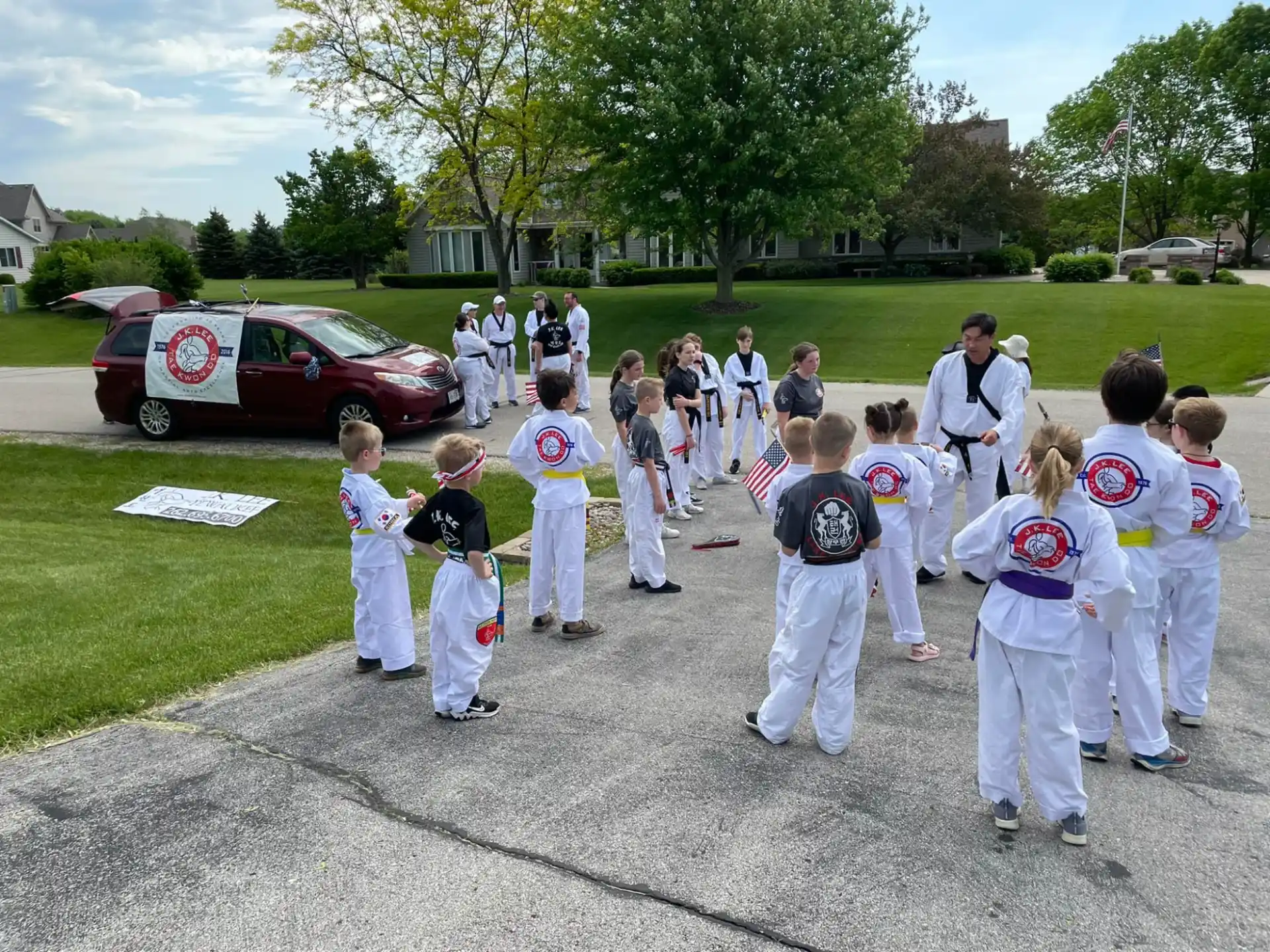 a group of people in white karate uniforms