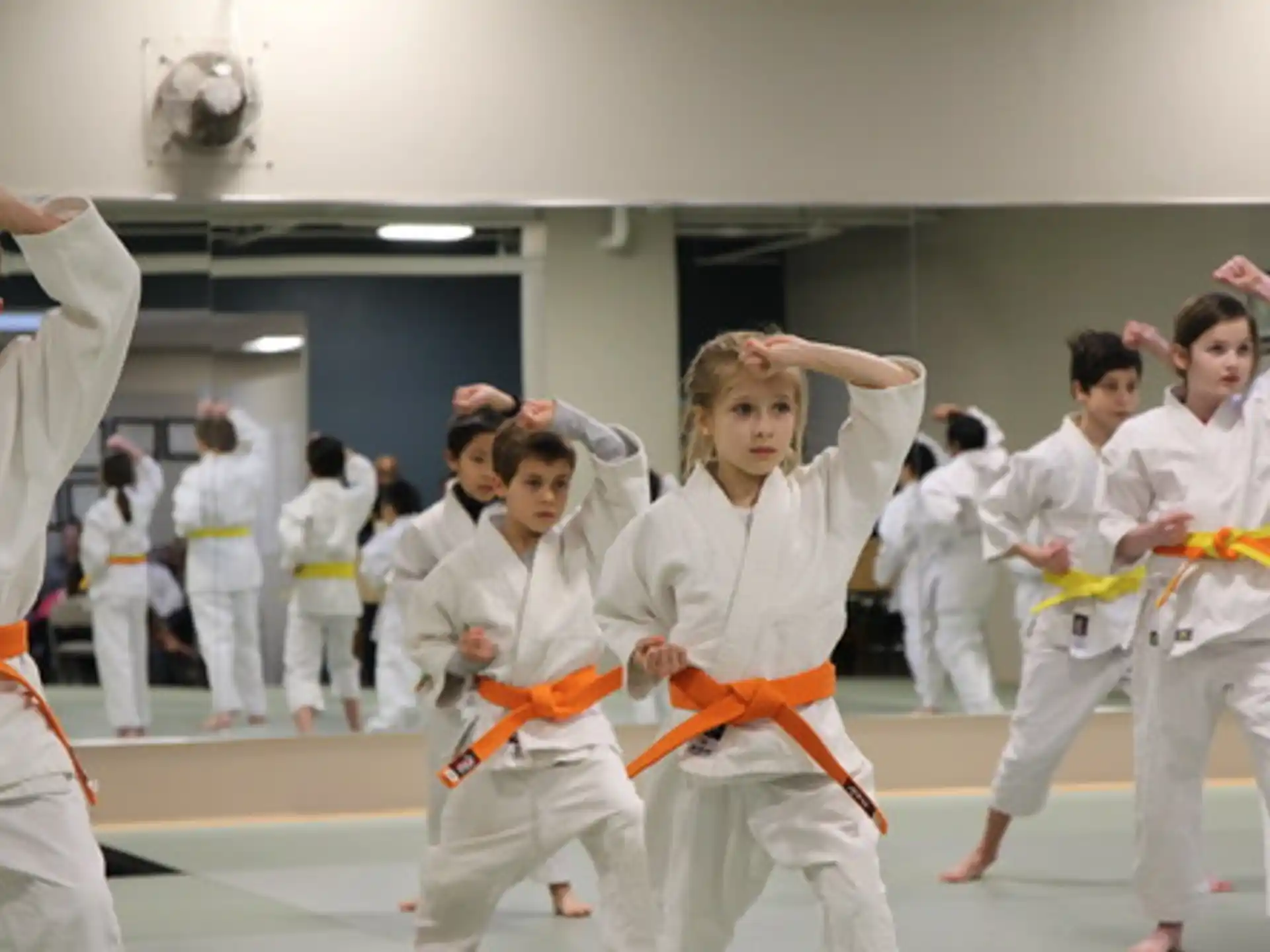 a group of people in white karate uniforms
