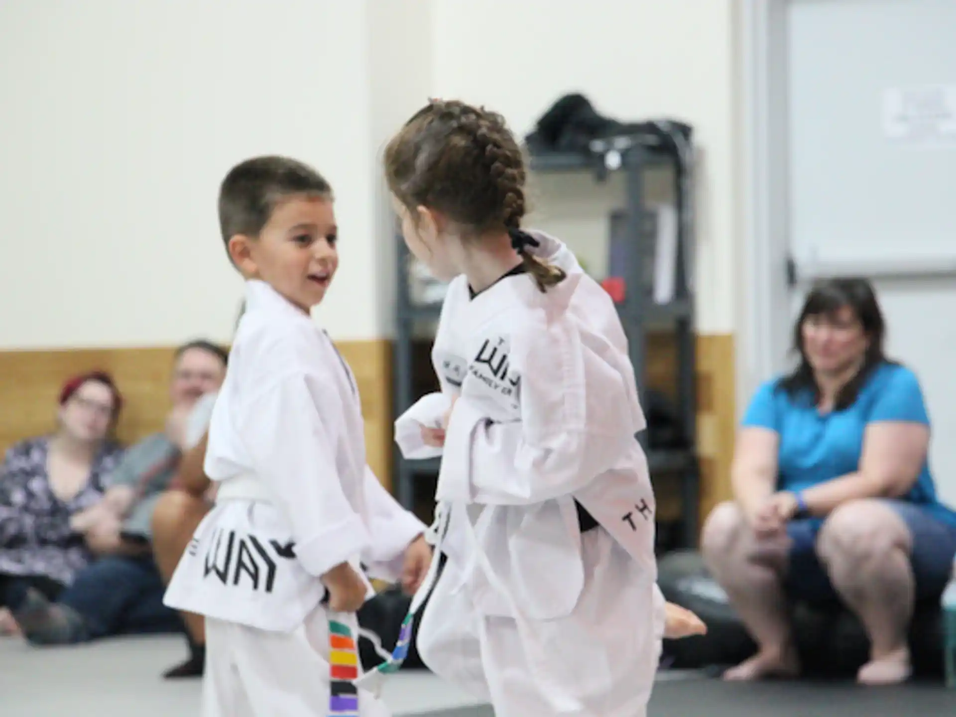 a couple of boys in karate uniforms
