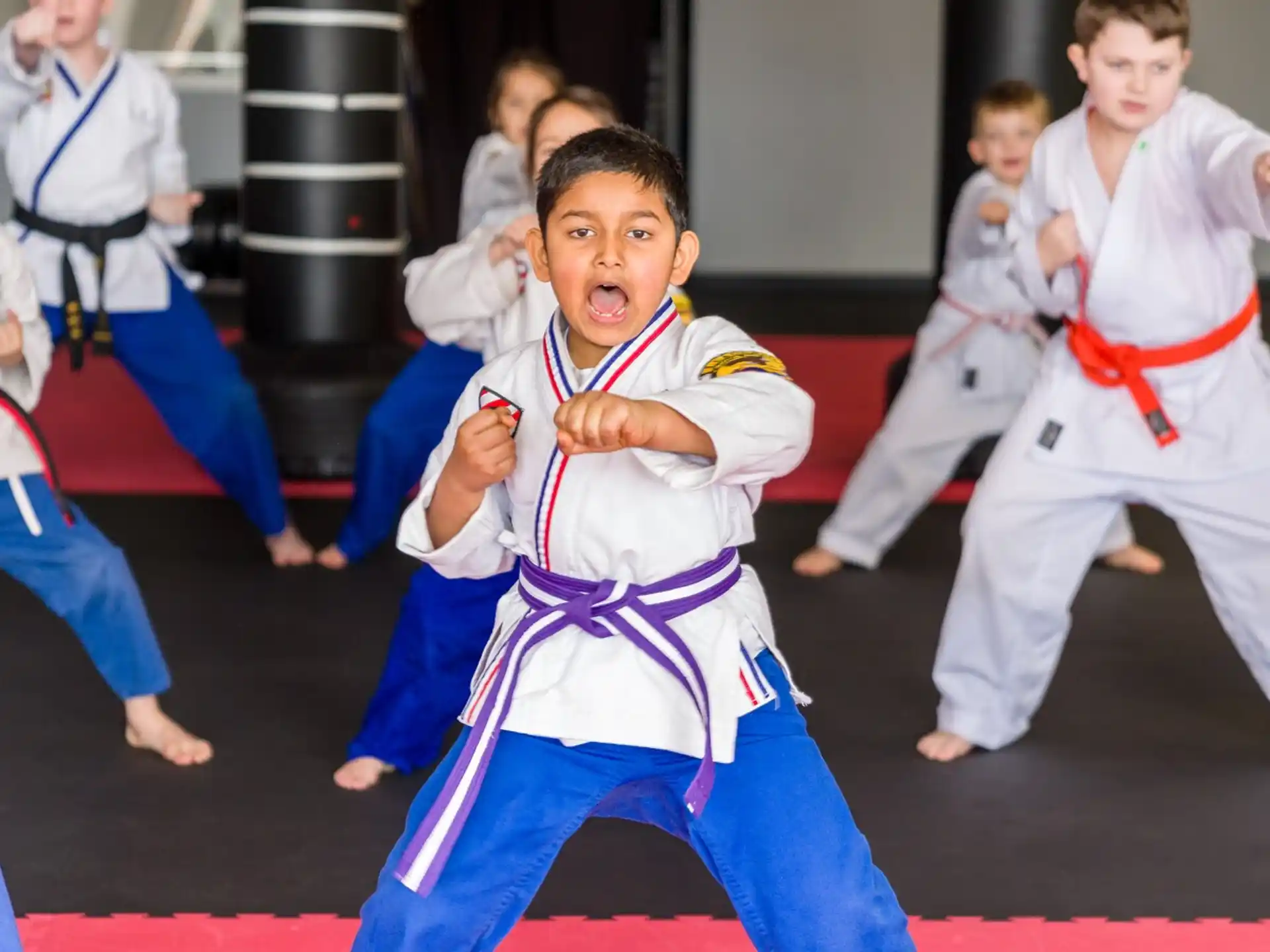 a group of children in karate uniforms
