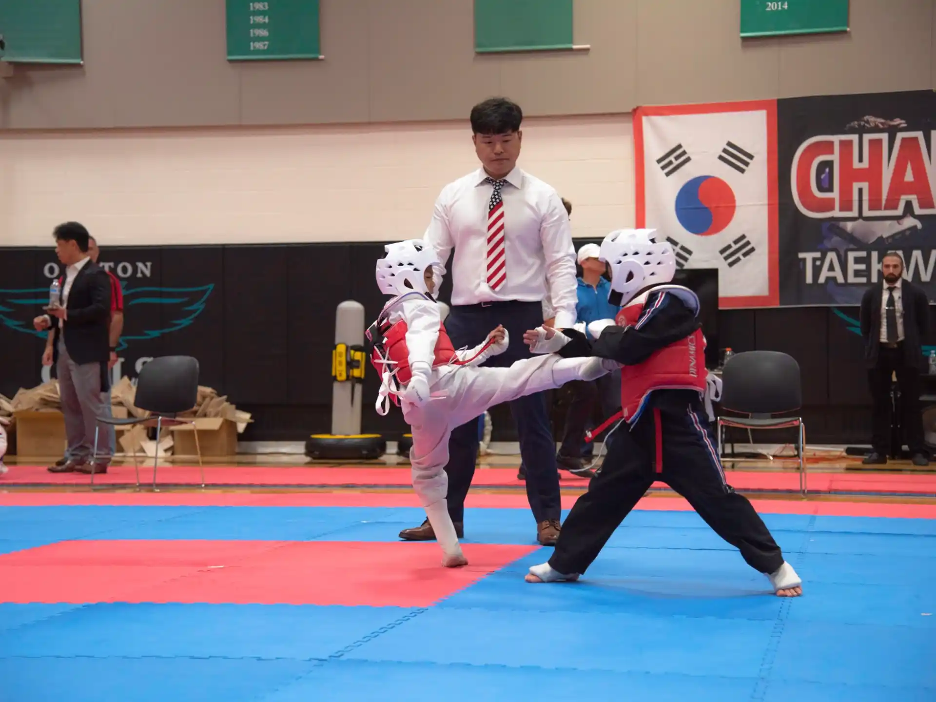 a person and two kids in a martial arts class
