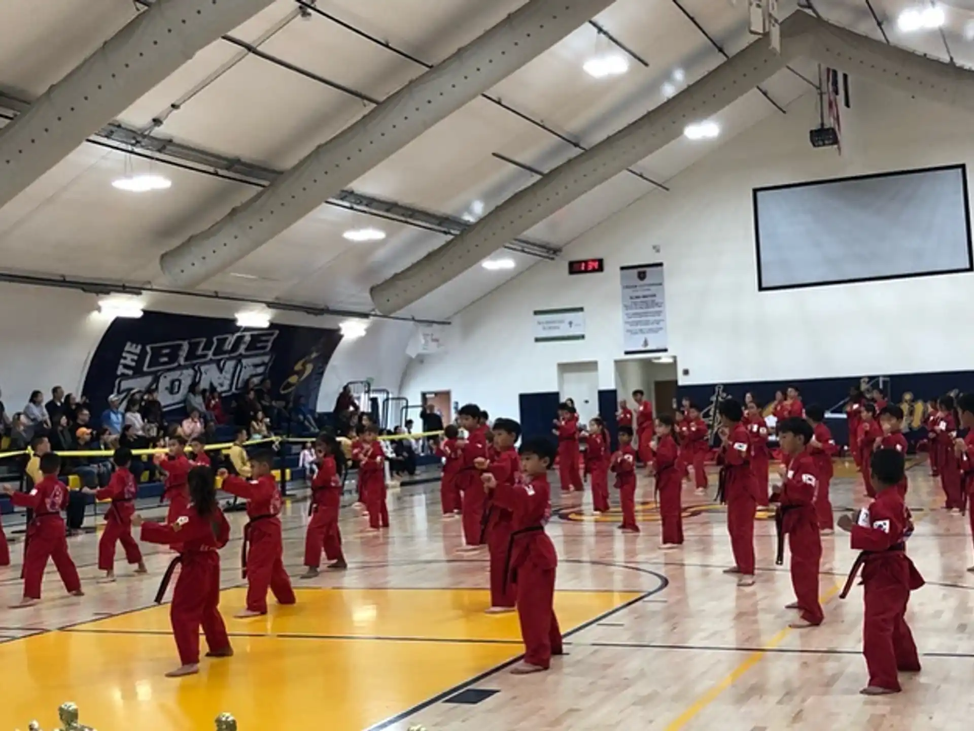 a group of people in red uniforms in a gym