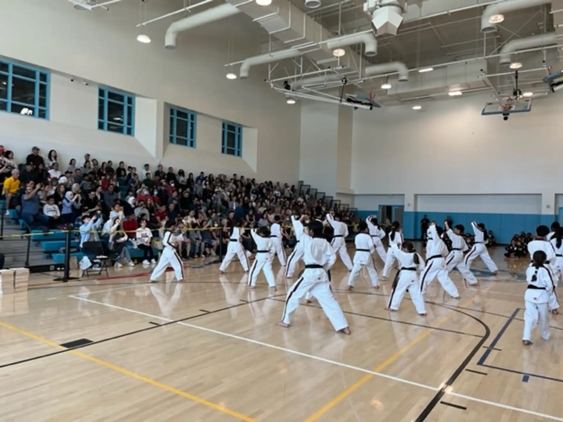 a group of people in white uniforms dancing on a basketball court