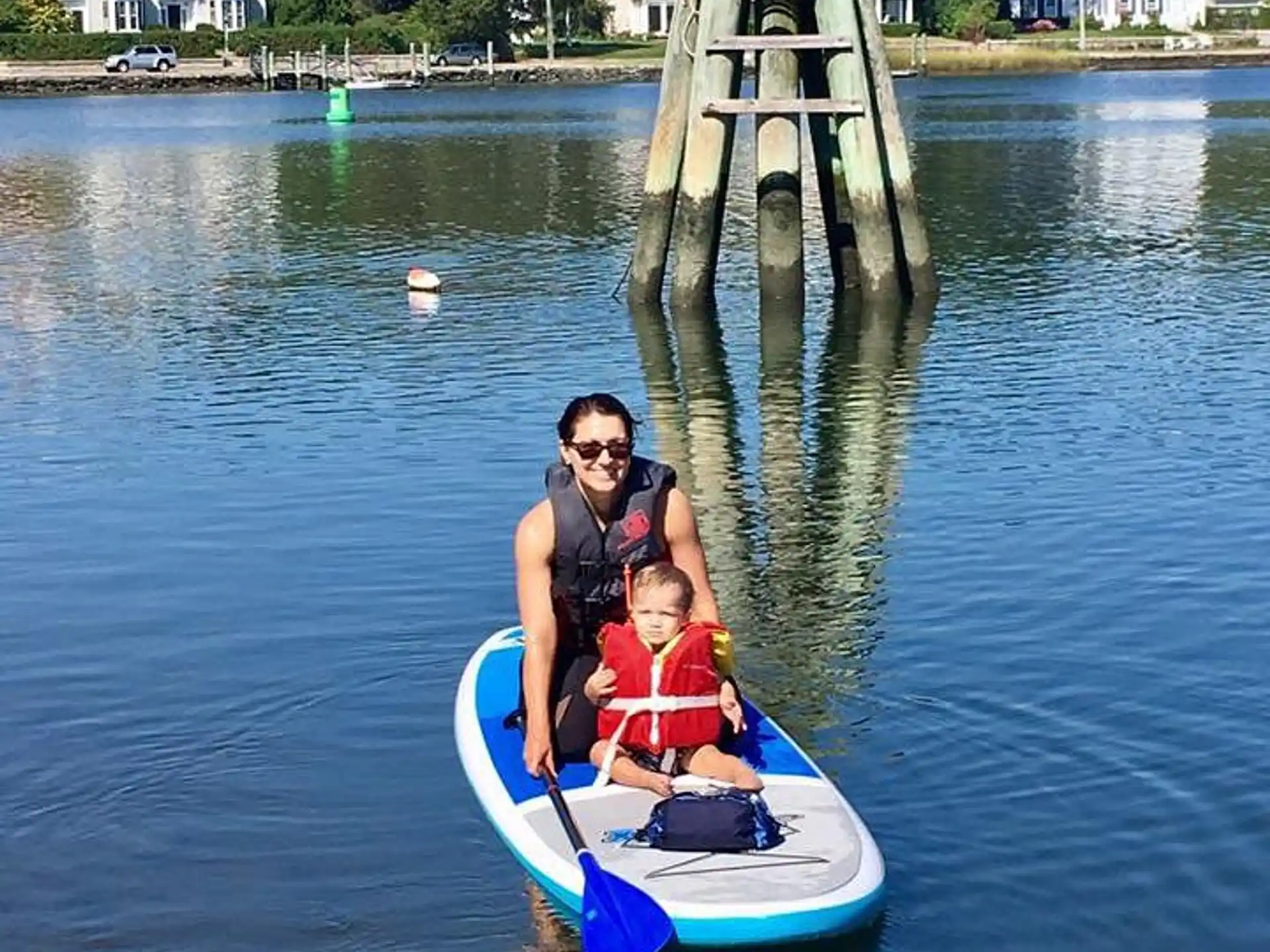 a person and a child on a small boat in a body of water