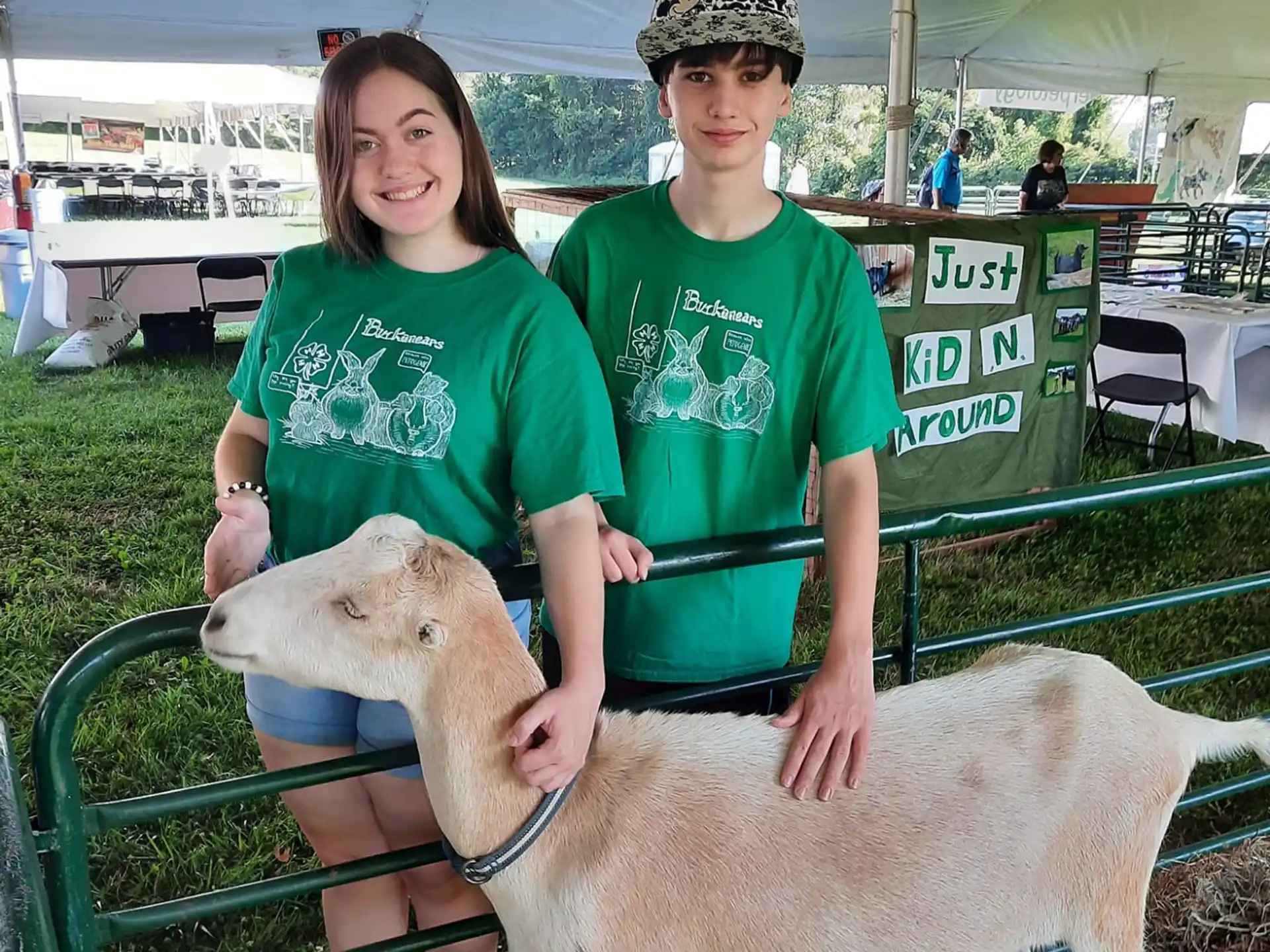 a man and a woman holding a sheep