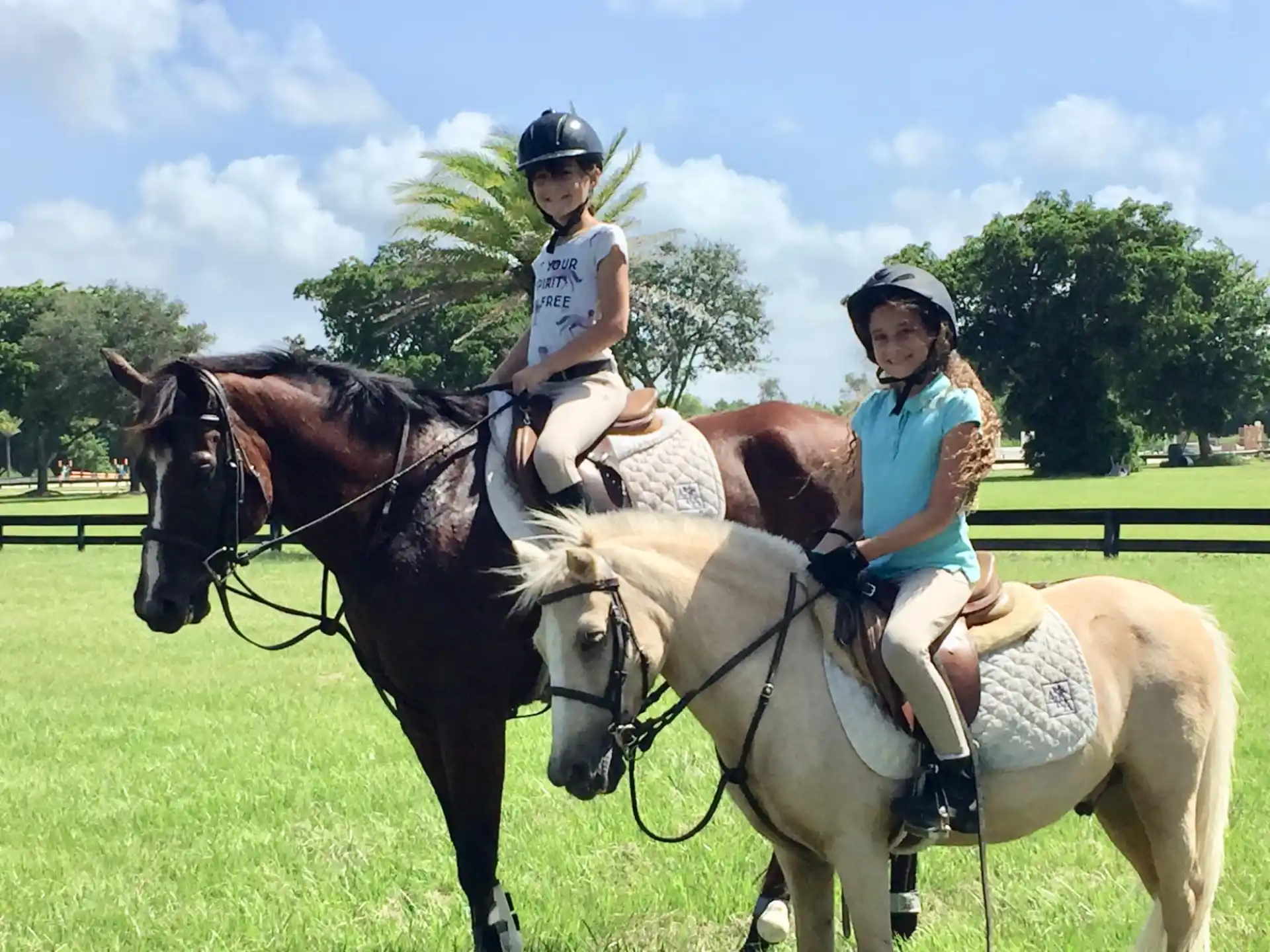 a couple of women riding horses