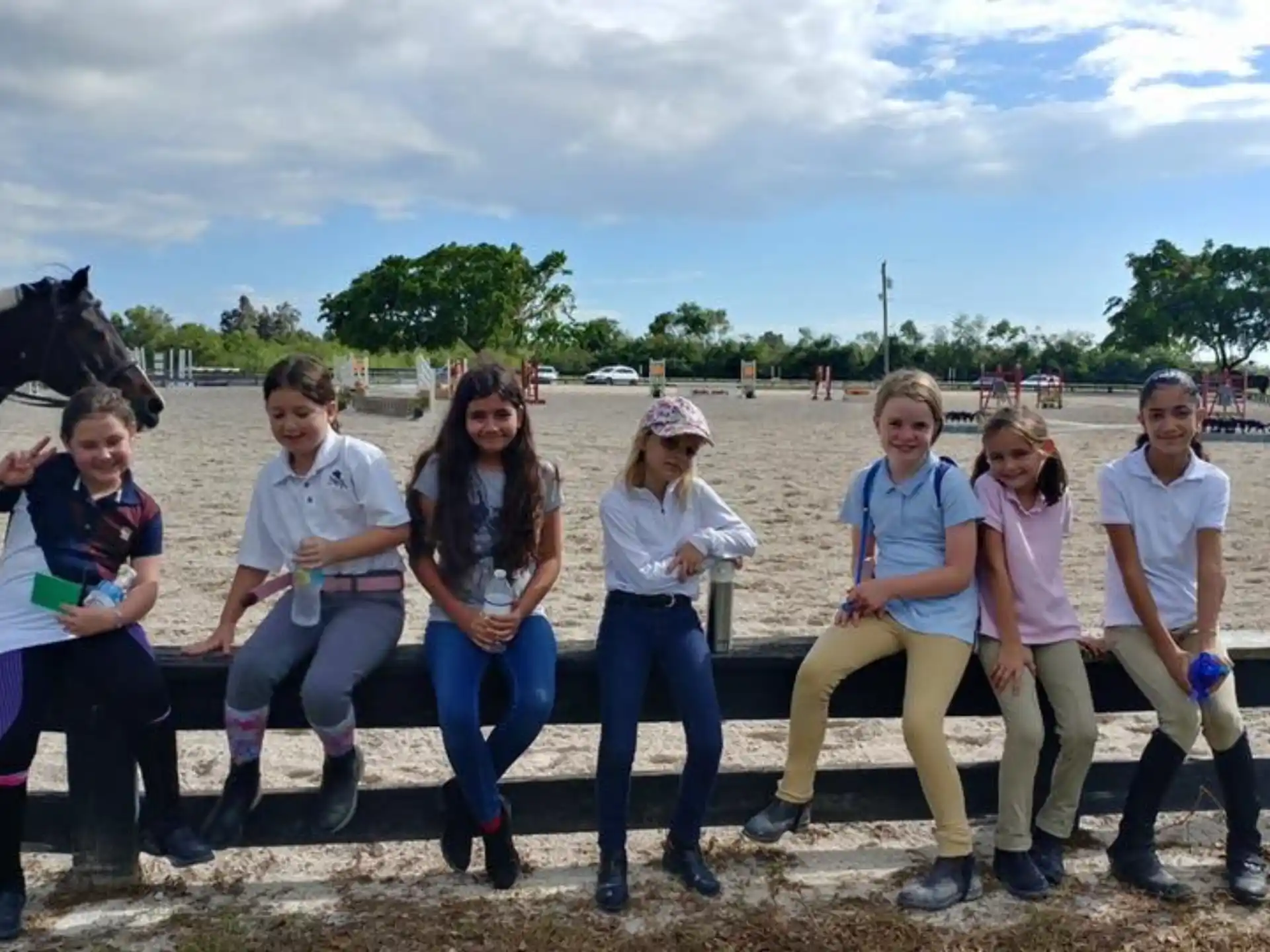 a group of people posing for a photo with a horse