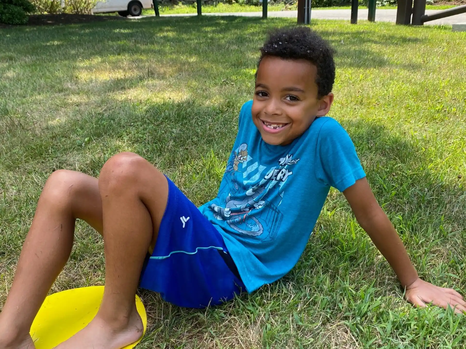 a boy lying on the grass