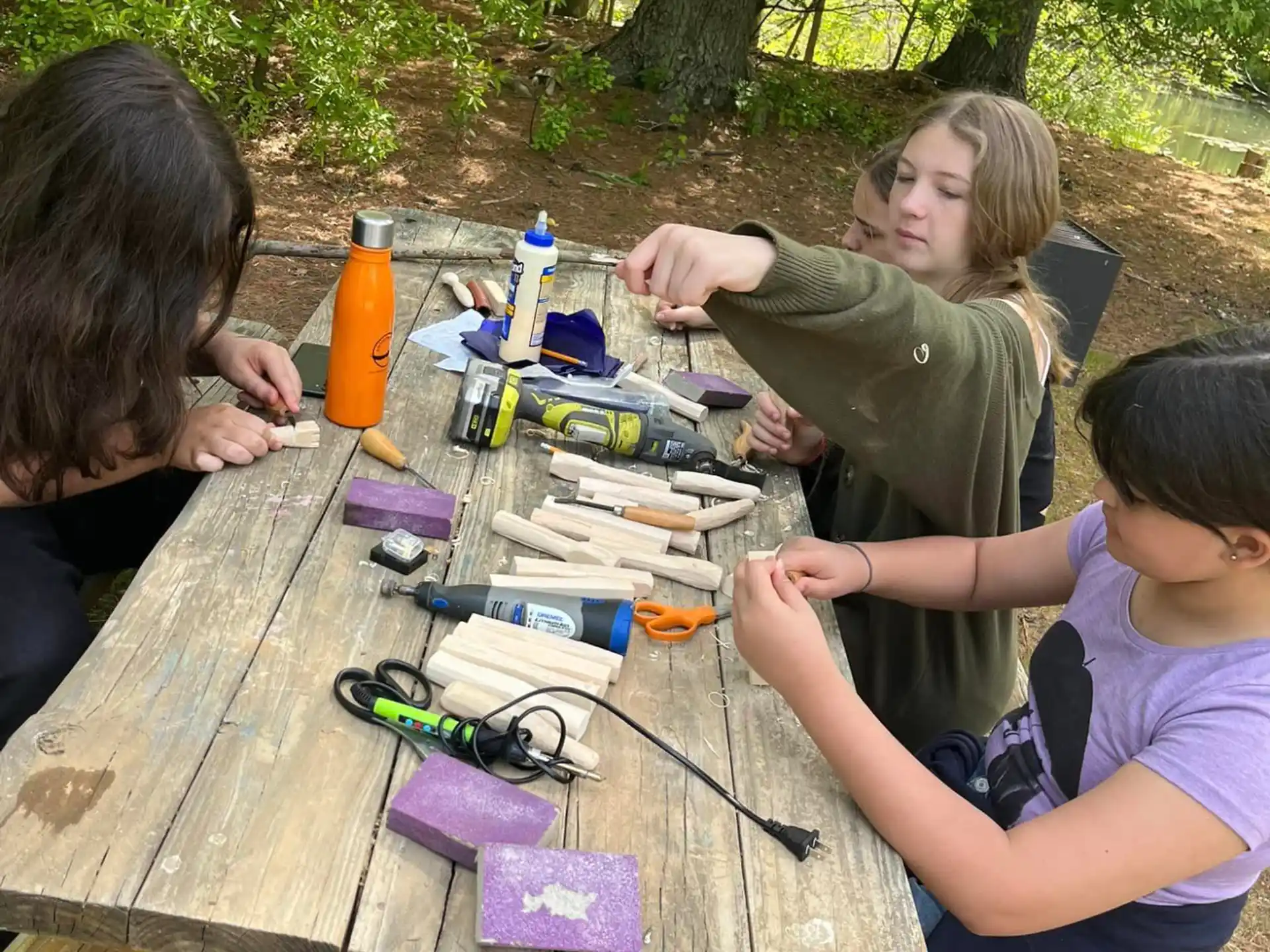 a group of people sitting at a table outside