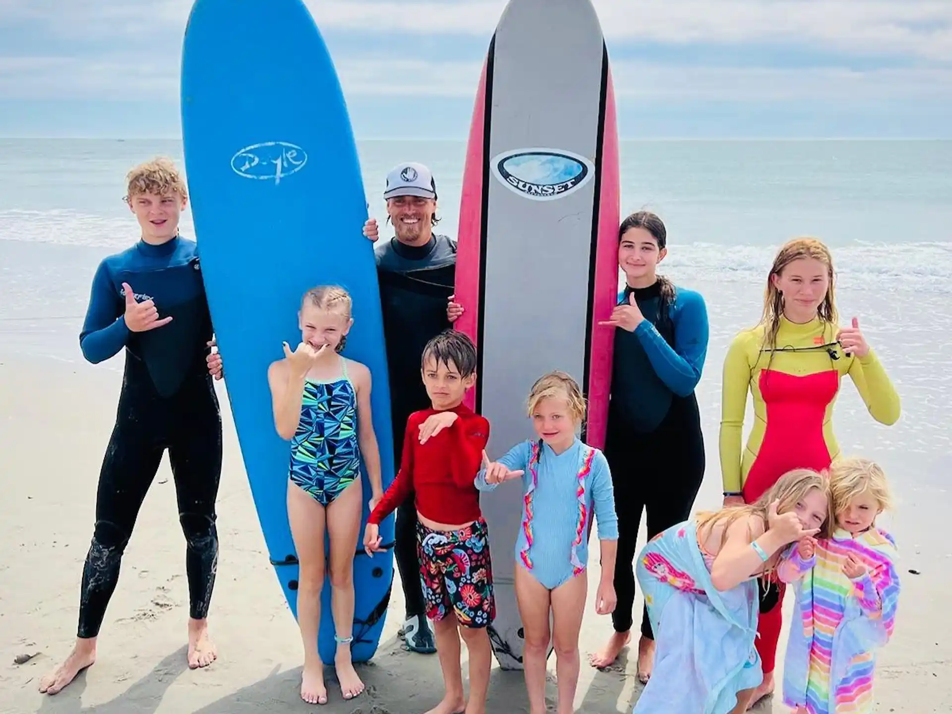 a group of people posing with surfboards