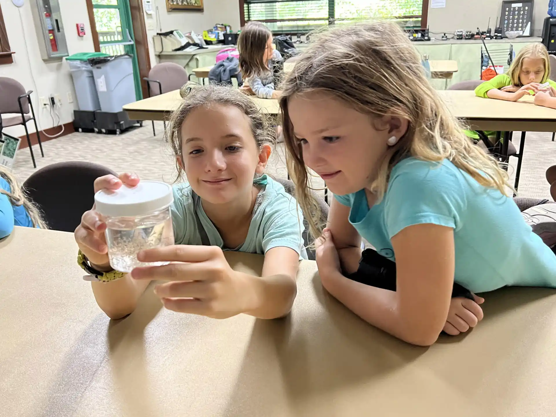 a few children sitting at a table