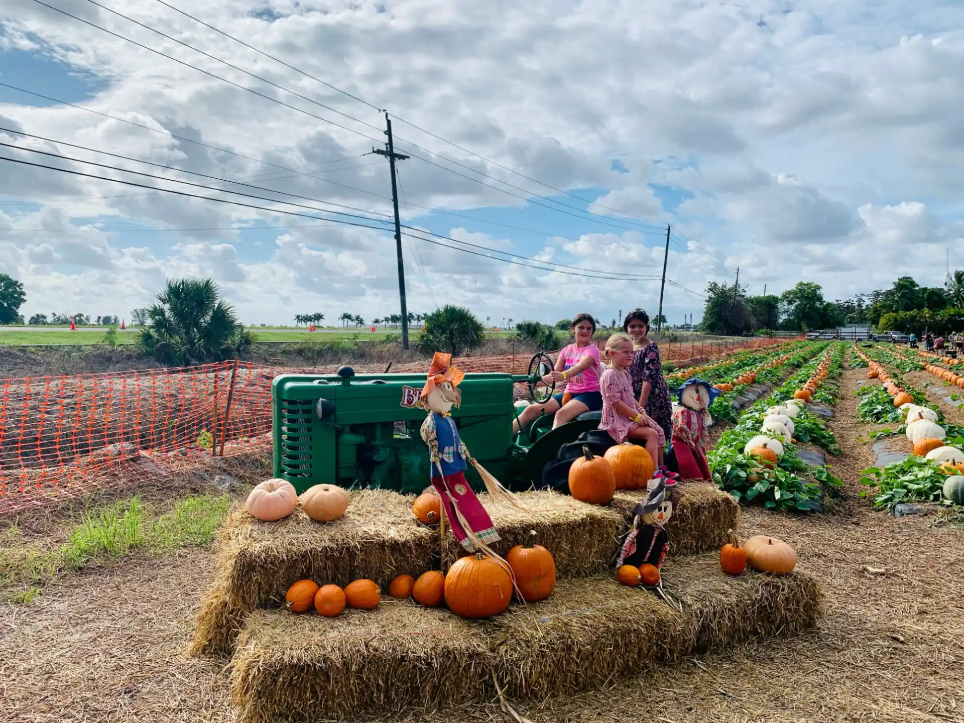 a group of people sitting on a tractor in a farm