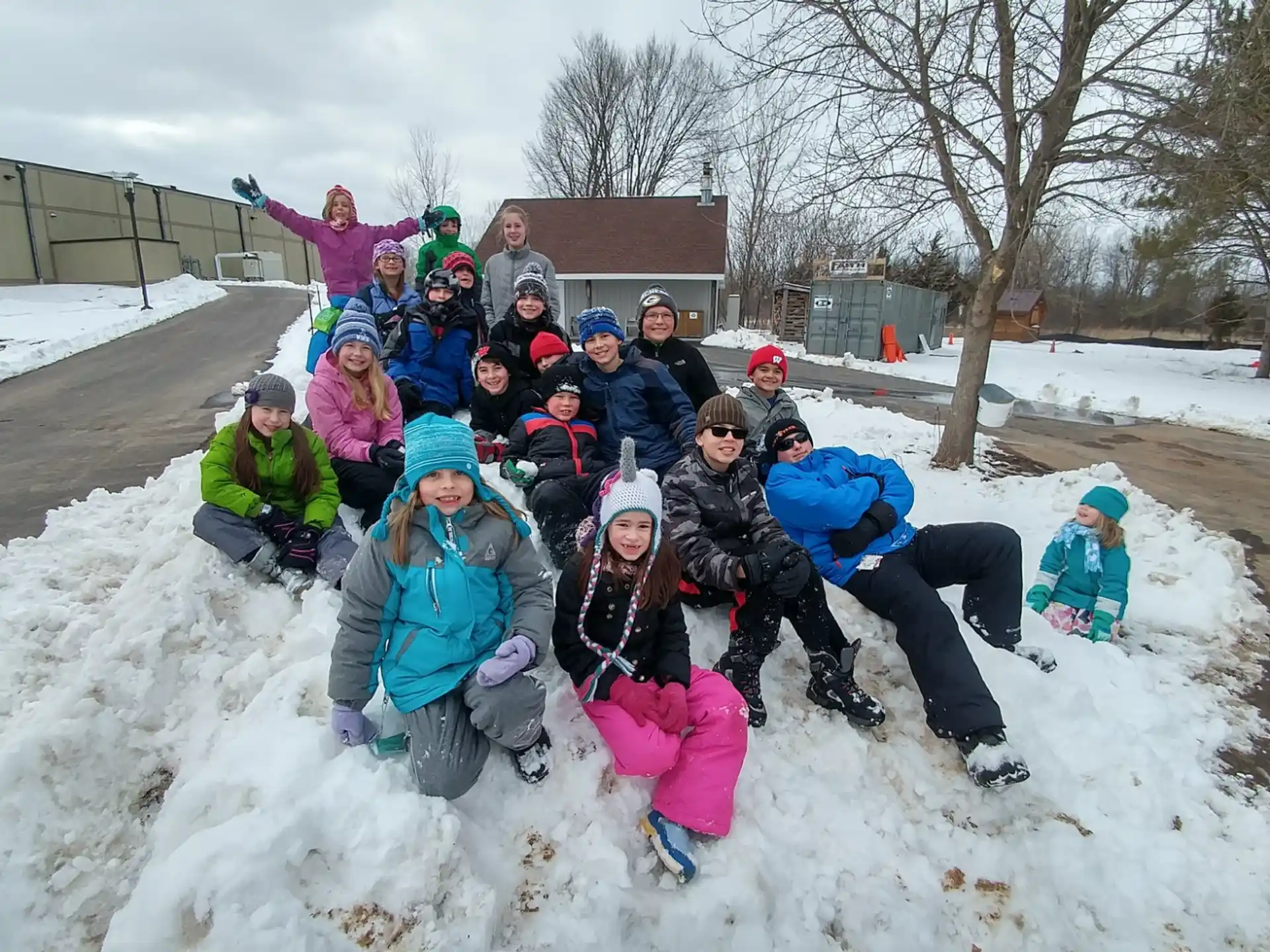 a group of people posing for a photo in the snow