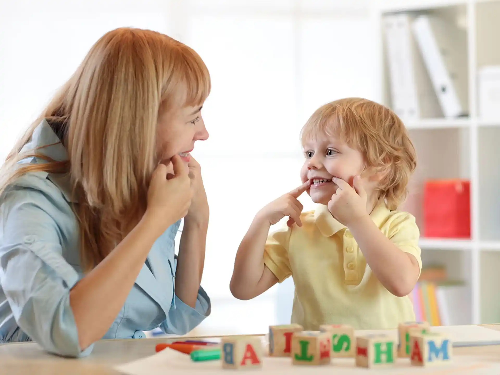 a woman and a child sitting at a table with food