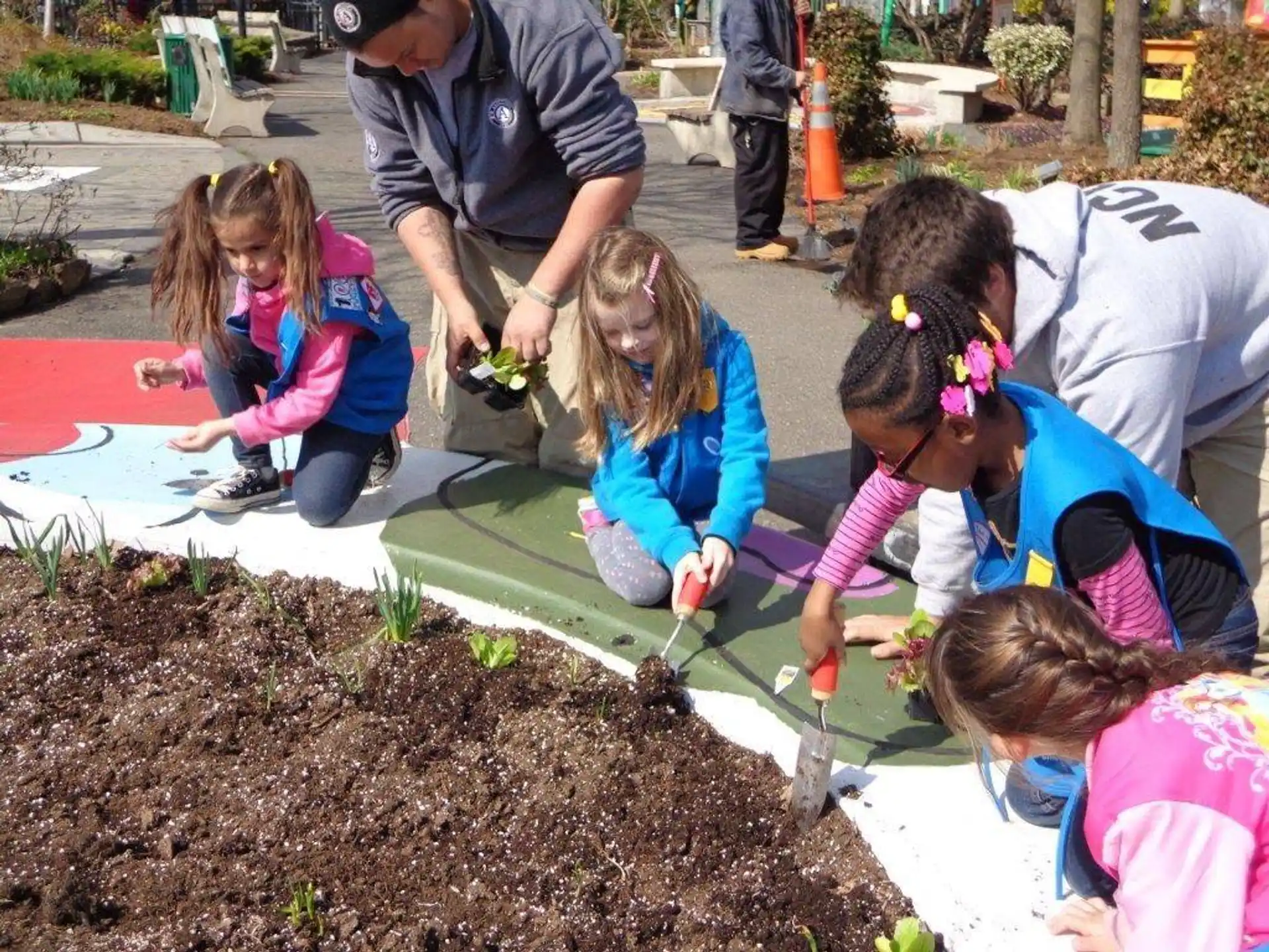 a group of children planting plants
