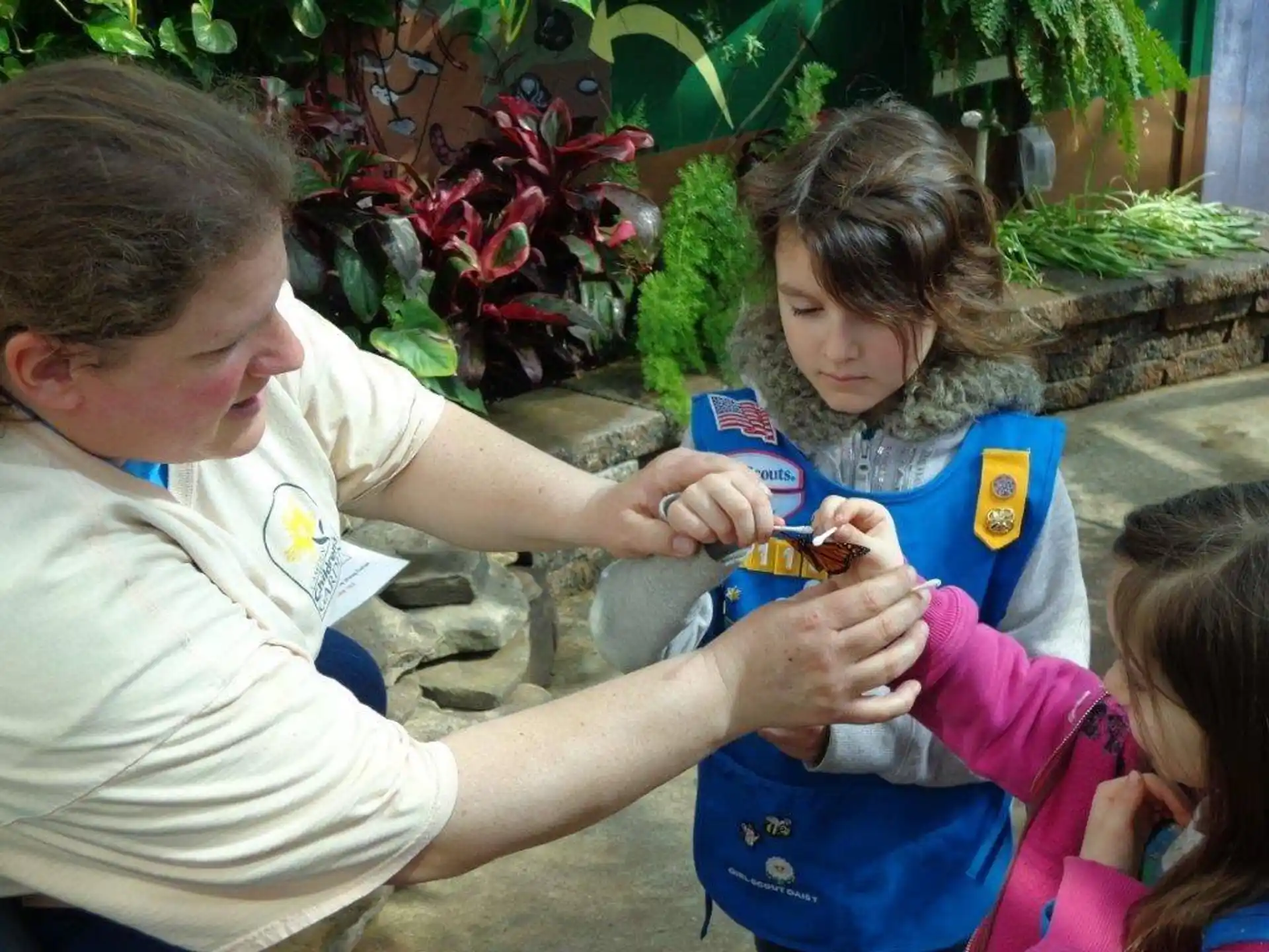 a man and a woman holding a child's hand