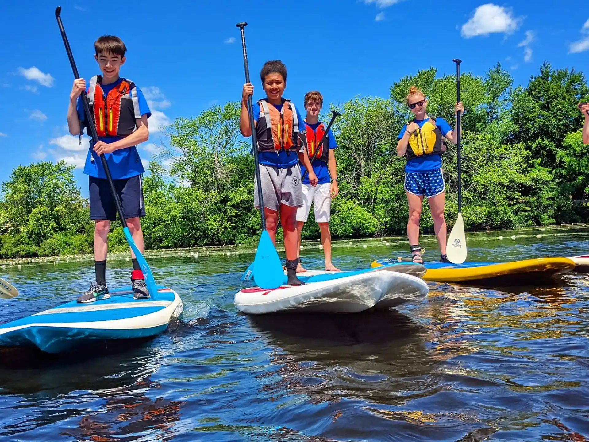 a group of people on paddle boards