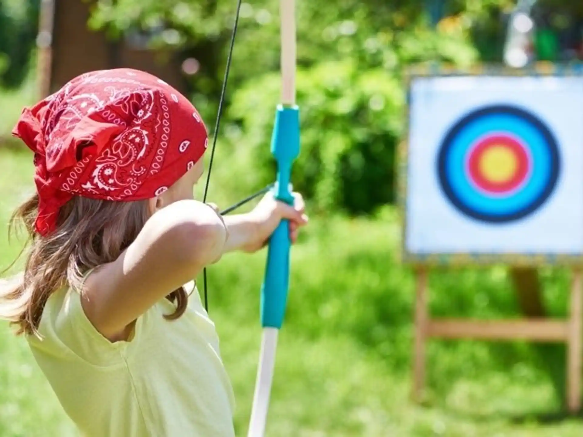 a girl holding a bow and arrow