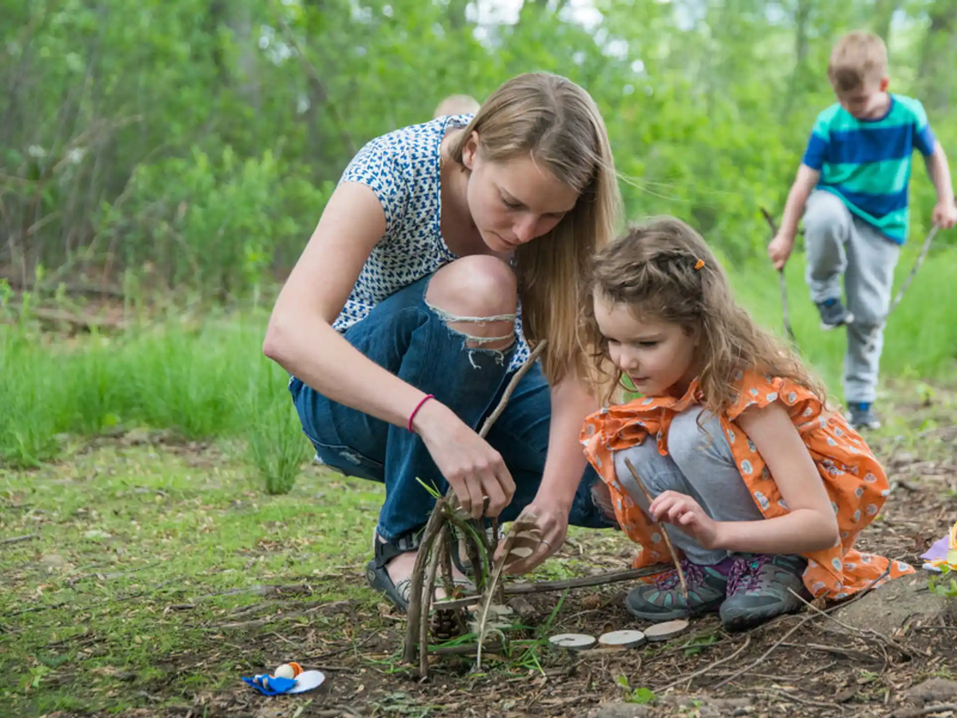 a person and a child playing with a toy