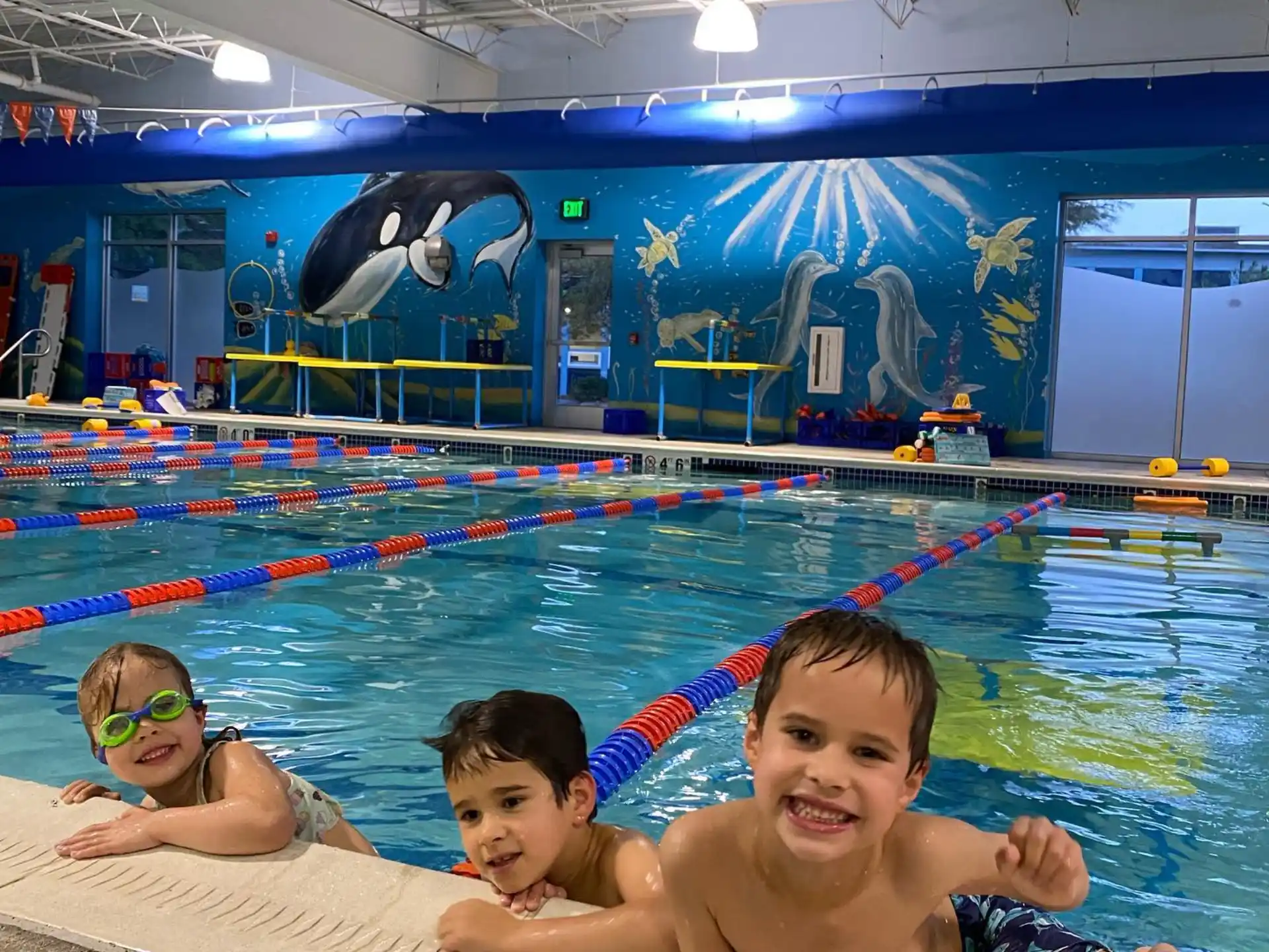a group of kids in a swimming pool