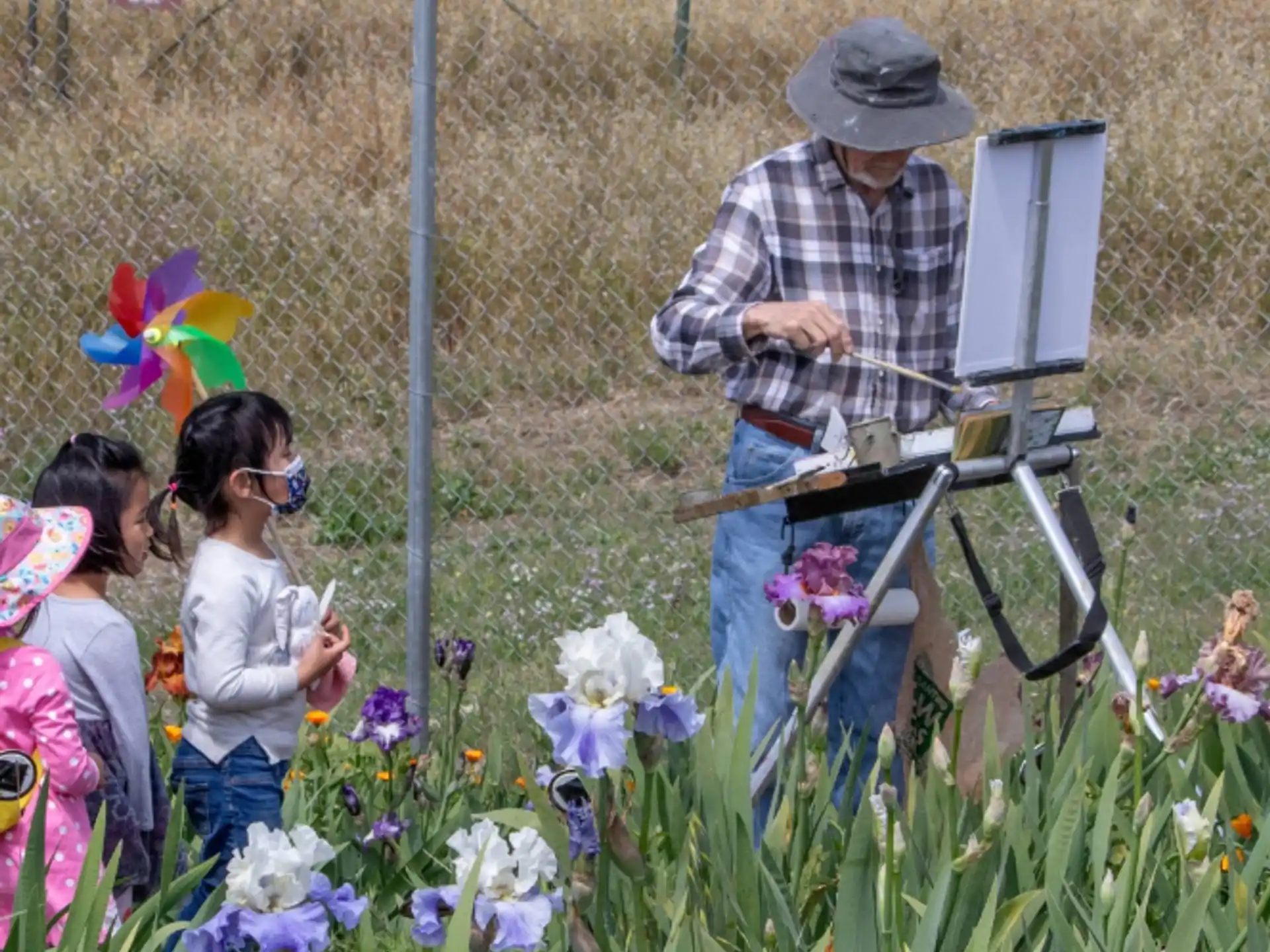 a person and a group of children looking at a person using a camera