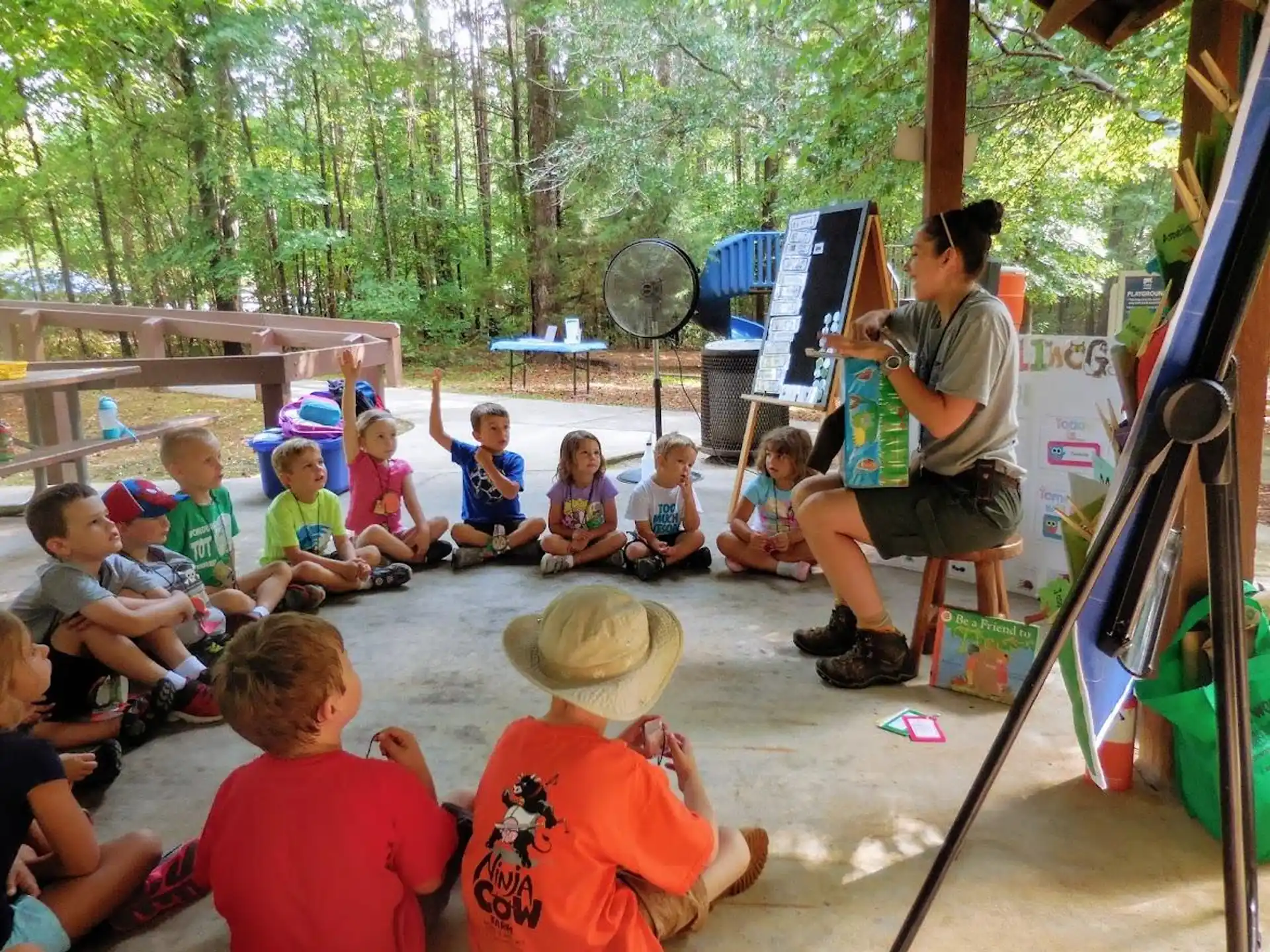 a person teaching children in a play area