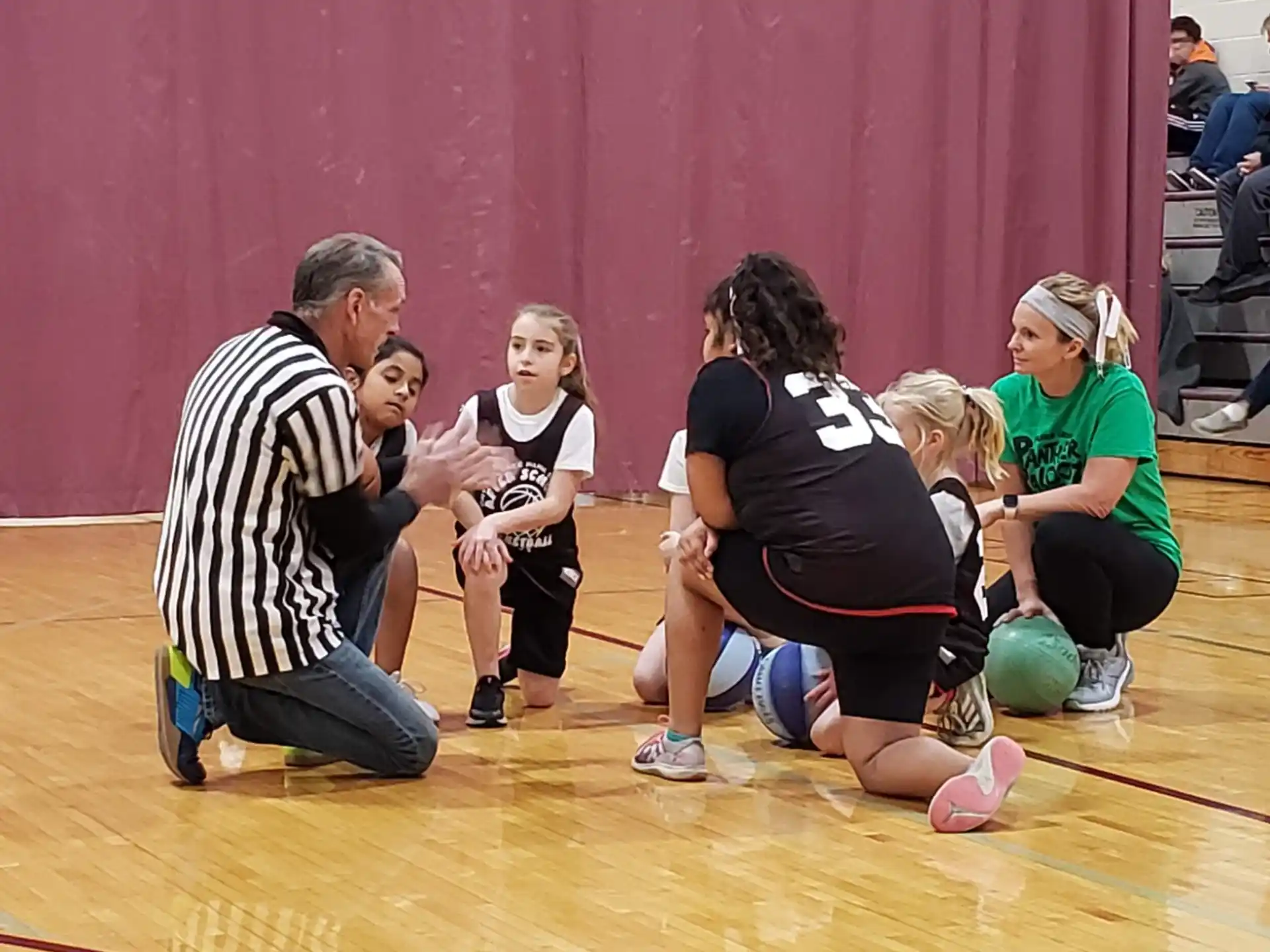 a group of people playing basketball